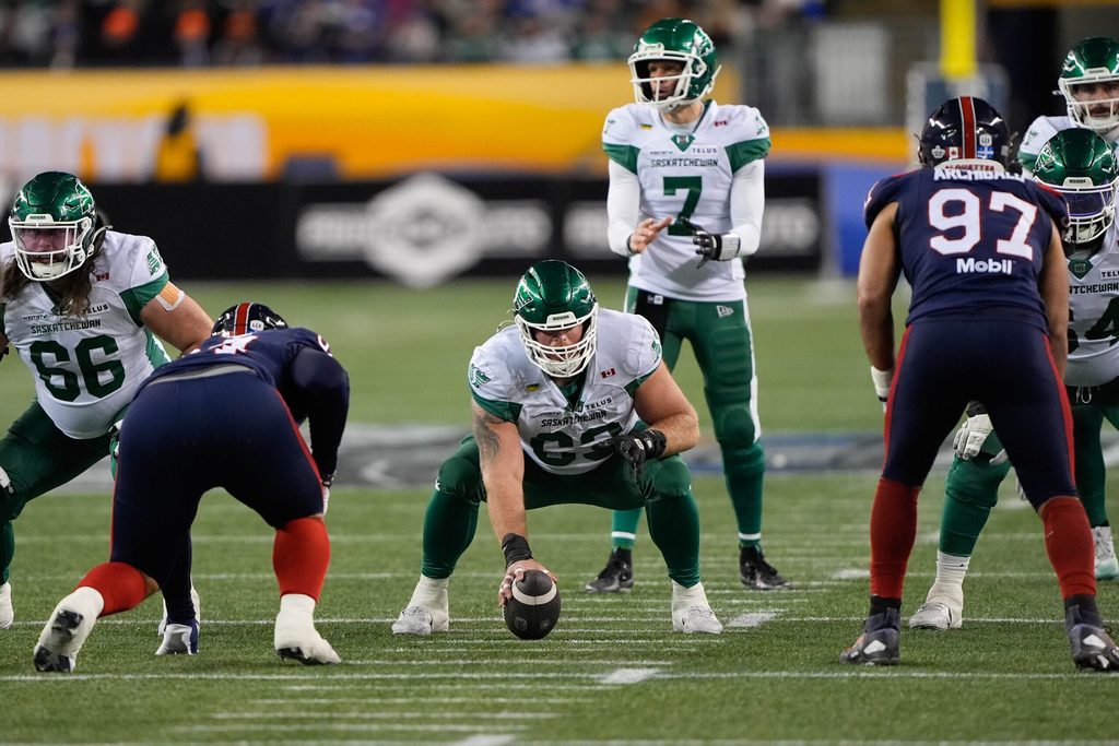 Nov 16, 2025; Winnipeg, Manitoba, Canada; Saskatchewan Roughriders center Logan Ferland (63) goes to snap the ball to quarterback Trevor Harris (7) during the 112th Grey Cup Championship against the Montreal Alouettes at Princess Auto Stadium. Mandatory Credit: John E. Sokolowski-Imagn Images