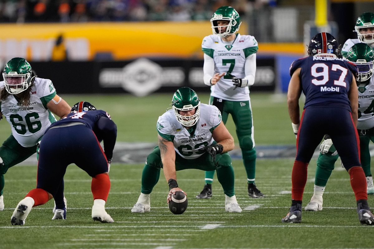 Nov 16, 2025; Winnipeg, Manitoba, Canada; Saskatchewan Roughriders center Logan Ferland (63) goes to snap the ball to quarterback Trevor Harris (7) during the 112th Grey Cup Championship against the Montreal Alouettes at Princess Auto Stadium. Mandatory Credit: John E. Sokolowski-Imagn Images