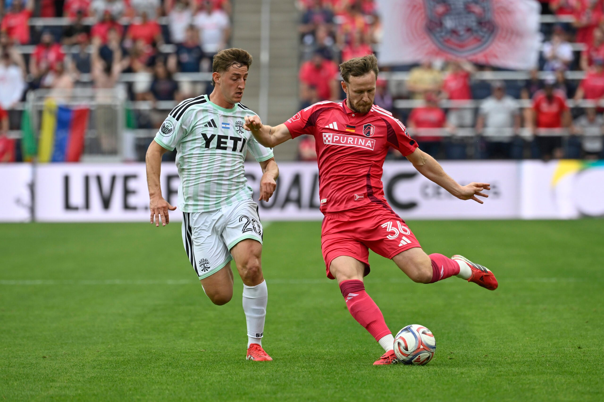 May 23, 2026; St. Louis, Missouri, USA; Austin FC midfielder Nicolas Dubersarsky (20) pressures St. Louis CITY SC forward Cedric Teuchert (36) in the second half at Energizer Park. Mandatory Credit: Joe Puetz-Imagn Images