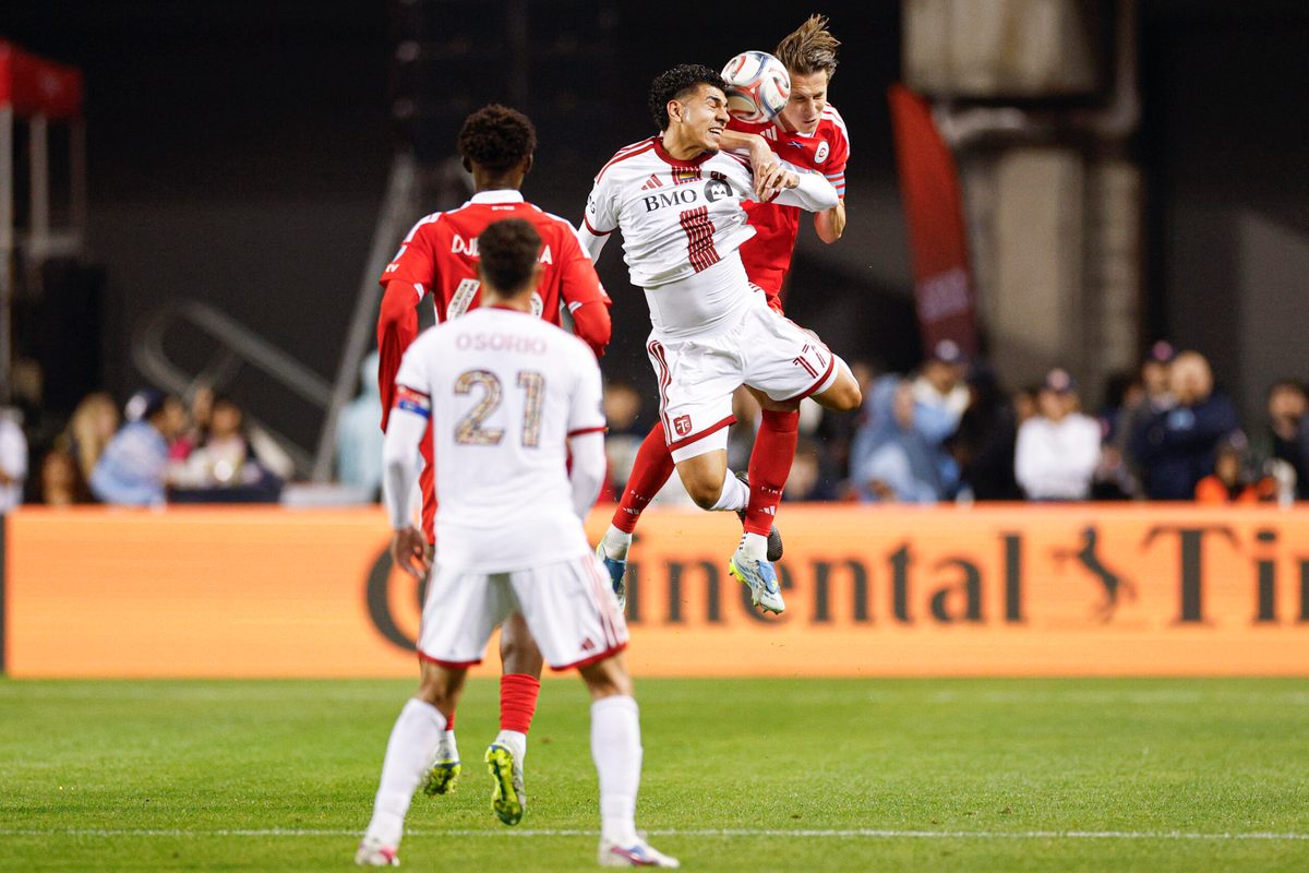 May 23, 2026; Chicago, Illinois, USA; Toronto FC forward Emilio Aristizábal (17) battles for the ball with Chicago Fire FC defender Jack Elliott (3) during the second half at Soldier Field. Mandatory Credit: Kamil Krzaczynski-Imagn Images