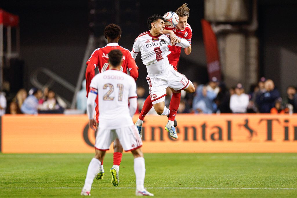 May 23, 2026; Chicago, Illinois, USA; Toronto FC forward Emilio Aristizábal (17) battles for the ball with Chicago Fire FC defender Jack Elliott (3) during the second half at Soldier Field. Mandatory Credit: Kamil Krzaczynski-Imagn Images