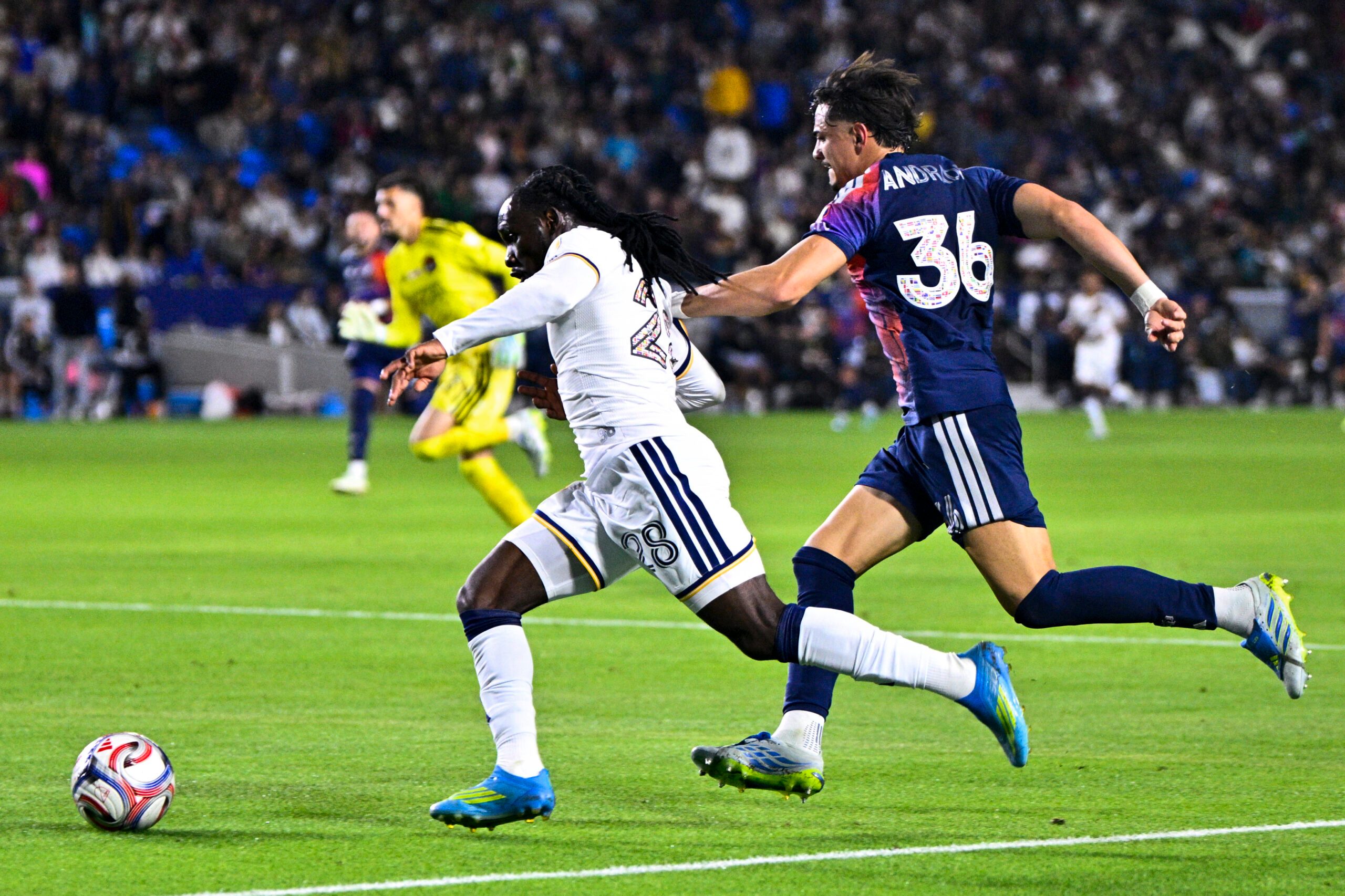 May 23, 2026; Carson, California, USA; LA Galaxy forward Joseph Paintsil (28) moves past Houston Dynamo FC defender Felipe Andrade (36) during the second half at Dignity Health Sports Park. Mandatory Credit: Kelvin Kuo-Imagn Images