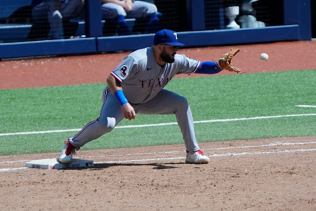 Jun 28, 2026; Toronto, Ontario, CAN; Texas Rangers first baseman Jake Burger (21) gets Toronto Blue Jays third baseman Kazuma Okamoto (not pictured) out at first base during the sixth inning at Rogers Centre. Mandatory Credit: John E. Sokolowski-Imagn Images