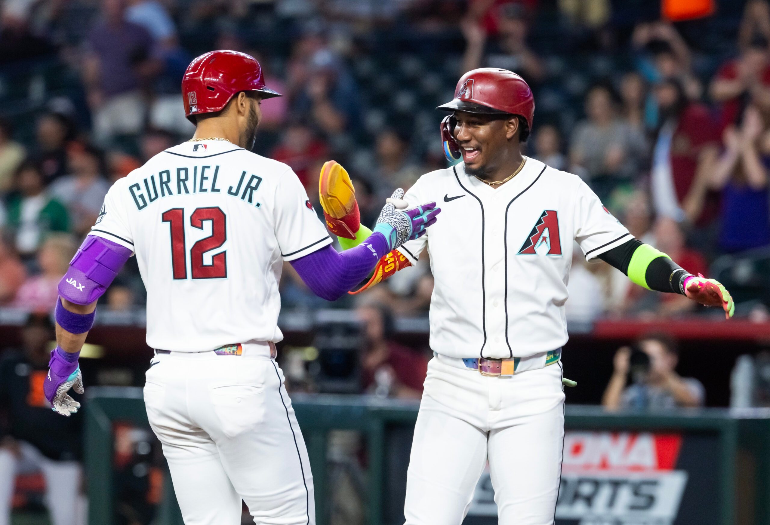 Jun 30, 2026; Phoenix, Arizona, USA; Arizona Diamondbacks outfielder Lourdes Gurriel Jr. (12) celebrates with teammate Geraldo Perdomo after hitting a three run home run in the first inning against the San Francisco Giants at Chase Field. Mandatory Credit: Mark J. Rebilas-Imagn Images