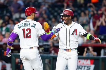 Jun 30, 2026; Phoenix, Arizona, USA; Arizona Diamondbacks outfielder Lourdes Gurriel Jr. (12) celebrates with teammate Geraldo Perdomo after hitting a three run home run in the first inning against the San Francisco Giants at Chase Field. Mandatory Credit: Mark J. Rebilas-Imagn Images