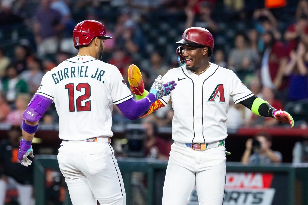 Jun 30, 2026; Phoenix, Arizona, USA; Arizona Diamondbacks outfielder Lourdes Gurriel Jr. (12) celebrates with teammate Geraldo Perdomo after hitting a three run home run in the first inning against the San Francisco Giants at Chase Field. Mandatory Credit: Mark J. Rebilas-Imagn Images