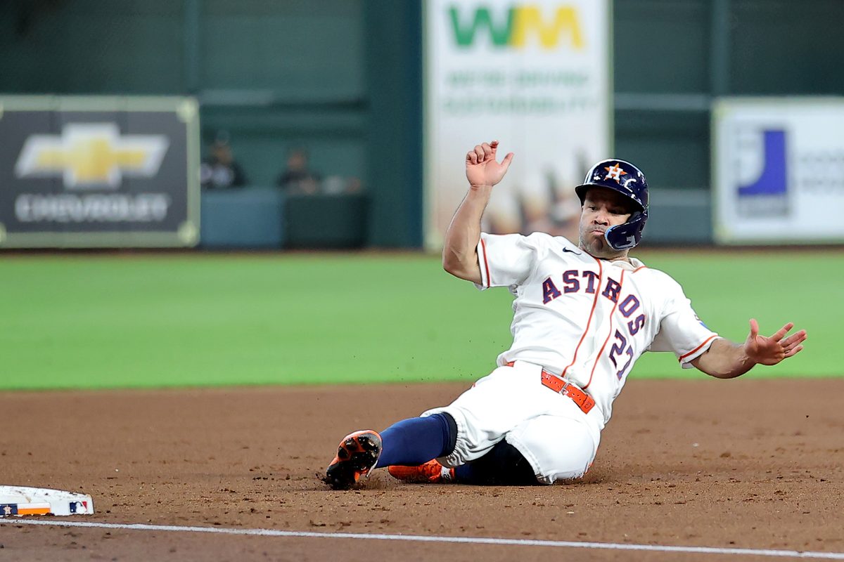 Jul 1, 2026; Houston, Texas, USA; Houston Astros second baseman Jose Altuve (27) slides into third base after a hit by designated hitter Yordan Alvarez (44, not shown) against the Minnesota Twins during the first inning at Daikin Park. Mandatory Credit: Erik Williams-Imagn Images