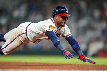 Jul 1, 2026; Cumberland, Georgia, USA; Atlanta Braves second baseman Ozzie Albies (1) slides into third base against the St. Louis Cardinals during the eighth inning at Truist Park. Mandatory Credit: Dale Zanine-Imagn Images