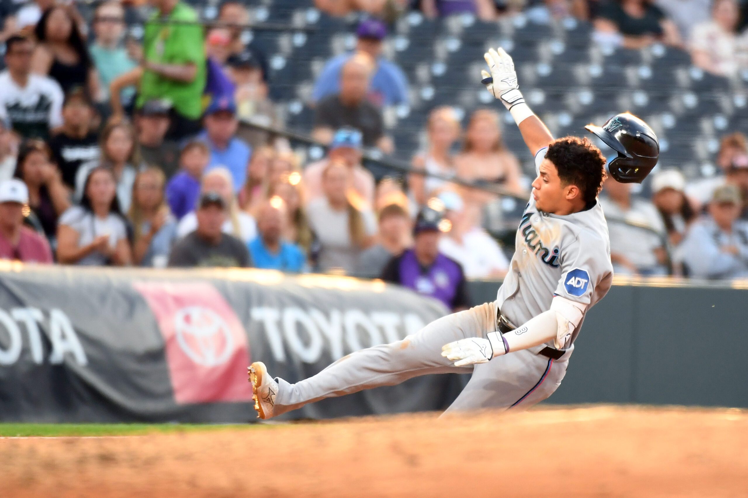 Jul 1, 2026; Denver, Colorado, USA; Miami Marlins infielder Javier Sanoja (8) slides safely into third base after an RBI triple in the fourth inning against the Miami Marlins at Coors Field. Mandatory Credit: Christopher Hanewinckel-Imagn Images
