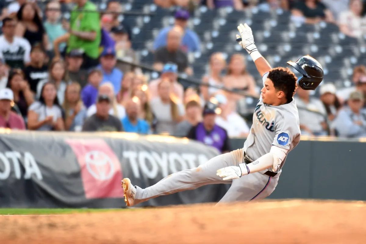 Jul 1, 2026; Denver, Colorado, USA; Miami Marlins infielder Javier Sanoja (8) slides safely into third base after an RBI triple in the fourth inning against the Miami Marlins at Coors Field. Mandatory Credit: Christopher Hanewinckel-Imagn Images