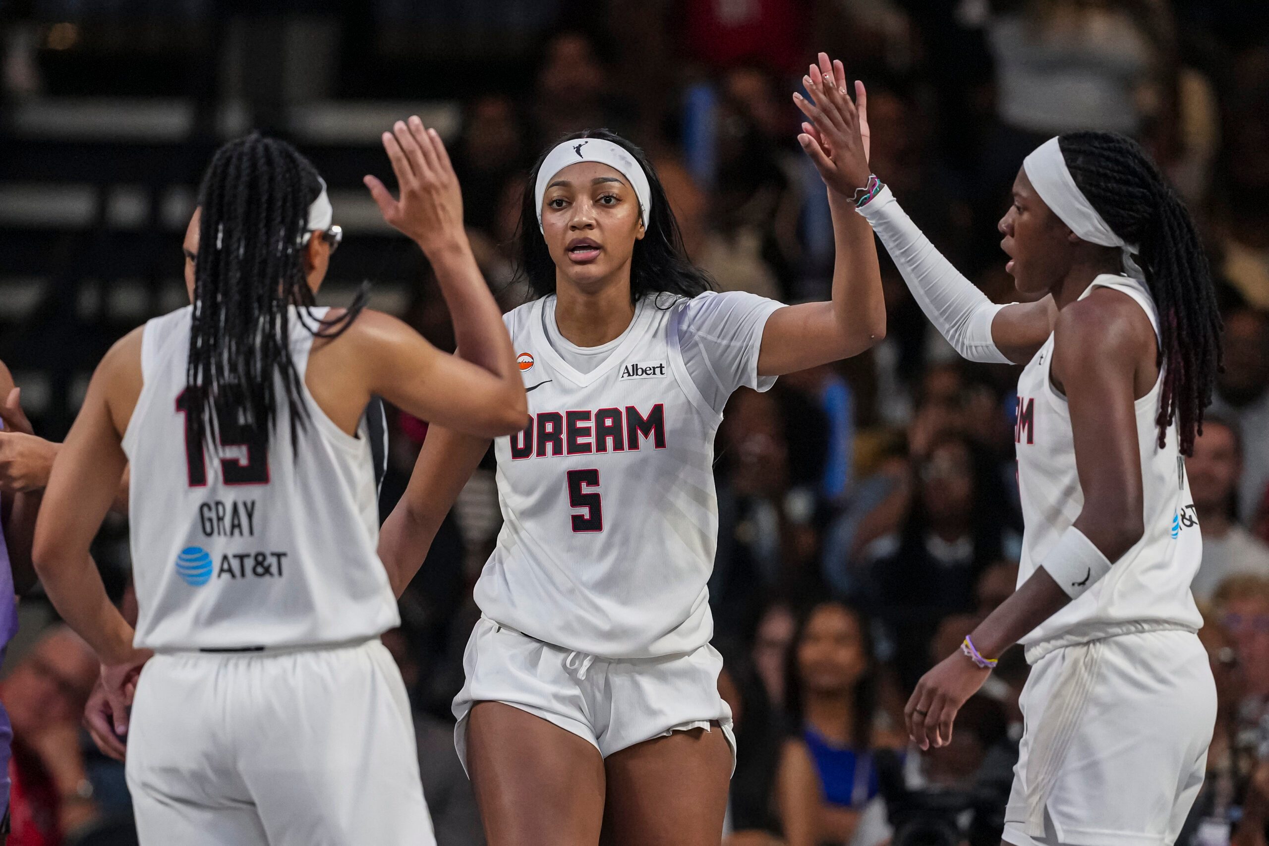 Jul 4, 2026; College Park, Georgia, USA; Atlanta Dream forward Angel Reese (5) react with guard Allisha Gray (15) and guard Rhyne Howard (10) against the Golden State Valkyries during the second half at Gateway Center Arena at College Park. Mandatory Credit: Dale Zanine-Imagn Images