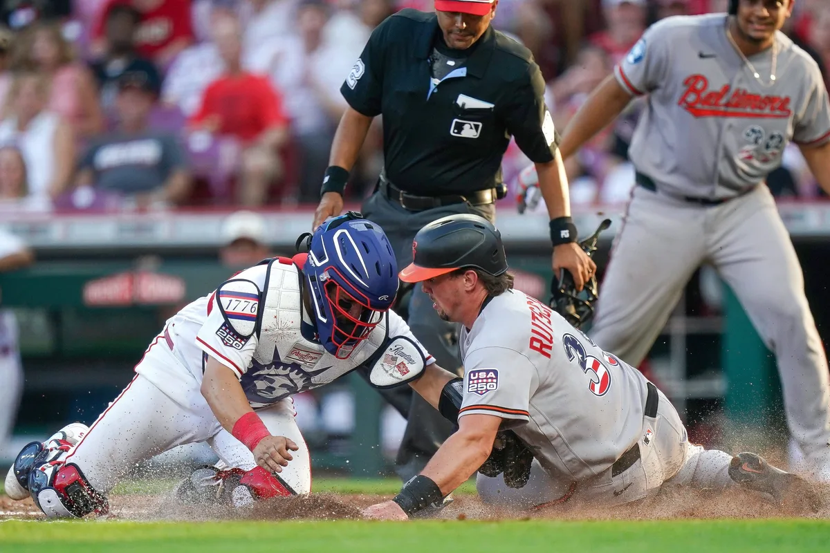 Cincinnati Reds catcher Jose Trevino (35) tags out Baltimore Orioles designated hitter Adley Rutschman (35) in the third inning of a MLB game between the Cincinnati Reds and Baltimore Orioles, Saturday, July 4, 2026, at Great American Ball Park in downtown Cincinnati.