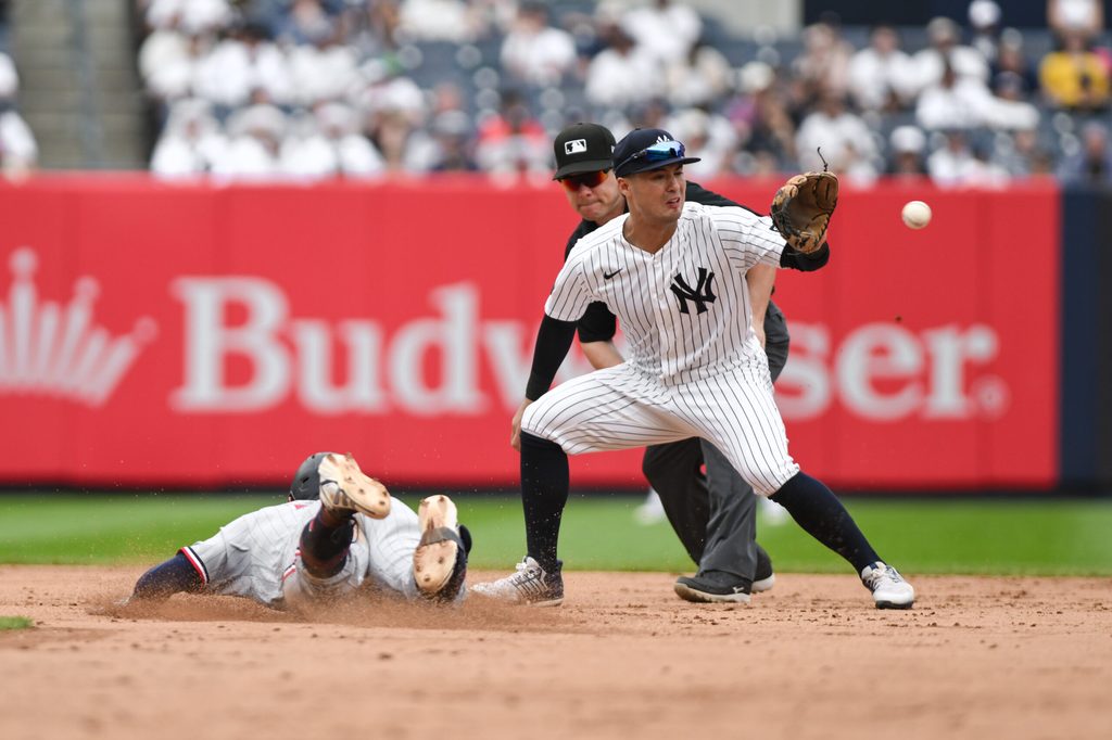Jul 5, 2026; Bronx, New York, USA; Minnesota Twins shortstop Brooks Lee (22) slides safely into second base with a double ahead of the throw to New York Yankees shortstop Anthony Volpe (11) during the sixth inning at Yankee Stadium. Mandatory Credit: John Jones-Imagn Images