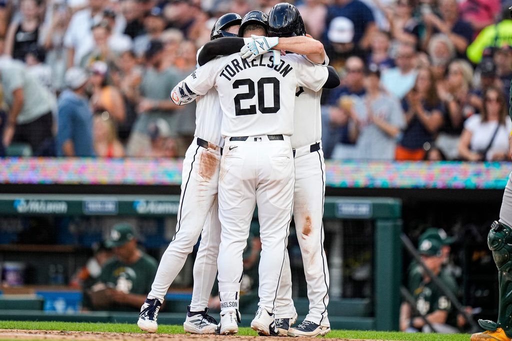 Detroit Tigers first baseman Spencer Torkelson (20) celebrates a three run home run against the Athletics with third baseman Kevin McGonigle (7) and catcher Jake Rogers (34) during the fifth inning at Comerica Park in Detroit on Wednesday, July 8, 2026.