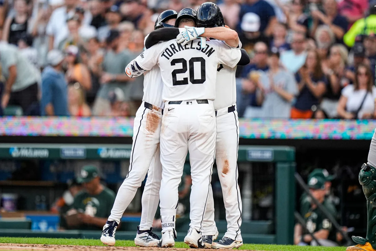 Detroit Tigers first baseman Spencer Torkelson (20) celebrates a three run home run against the Athletics with third baseman Kevin McGonigle (7) and catcher Jake Rogers (34) during the fifth inning at Comerica Park in Detroit on Wednesday, July 8, 2026.