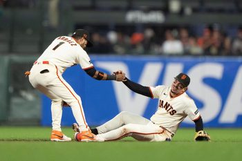 Jul 9, 2026; San Francisco, California, USA;  San Francisco Giants second baseman Luis Arraez (1) helps shortstop Willy Adames (2) during the seventh inning against the Colorado Rockies at Oracle Park. Mandatory Credit: Stan Szeto-Imagn Images