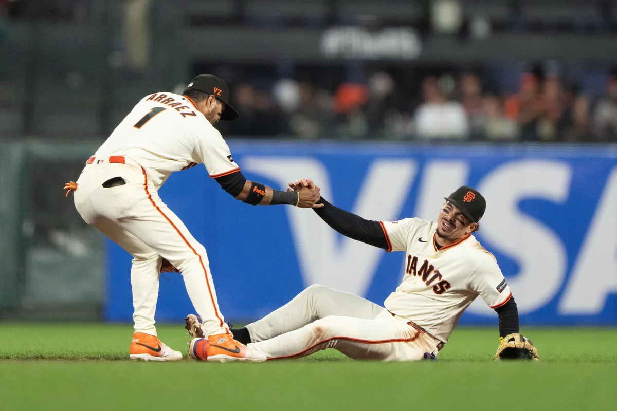Jul 9, 2026; San Francisco, California, USA; San Francisco Giants second baseman Luis Arraez (1) helps shortstop Willy Adames (2) during the seventh inning against the Colorado Rockies at Oracle Park. Mandatory Credit: Stan Szeto-Imagn Images
