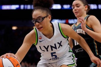 Jul 11, 2026; Minneapolis, Minnesota, USA; Minnesota Lynx guard Olivia Miles (5) grabs a rebound ahead of New York Liberty forward Pauline Astier (18) late in the fourth quarter at Target Center. Mandatory Credit: Bruce Kluckhohn-Imagn Images