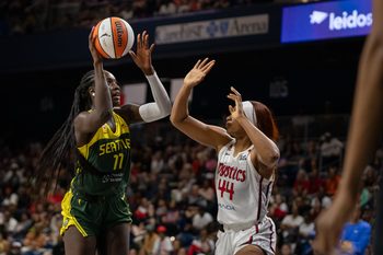 Jul 12, 2026; Washington, District of Columbia, USA; Seattle Storm Center Awa Fam (11) attempts a shot against Washington Mystics Forward Kiki Iriafen (44) in the fourth quarter at CareFirst Arena. Mandatory Credit: Jamie LeBlanc-Imagn Images