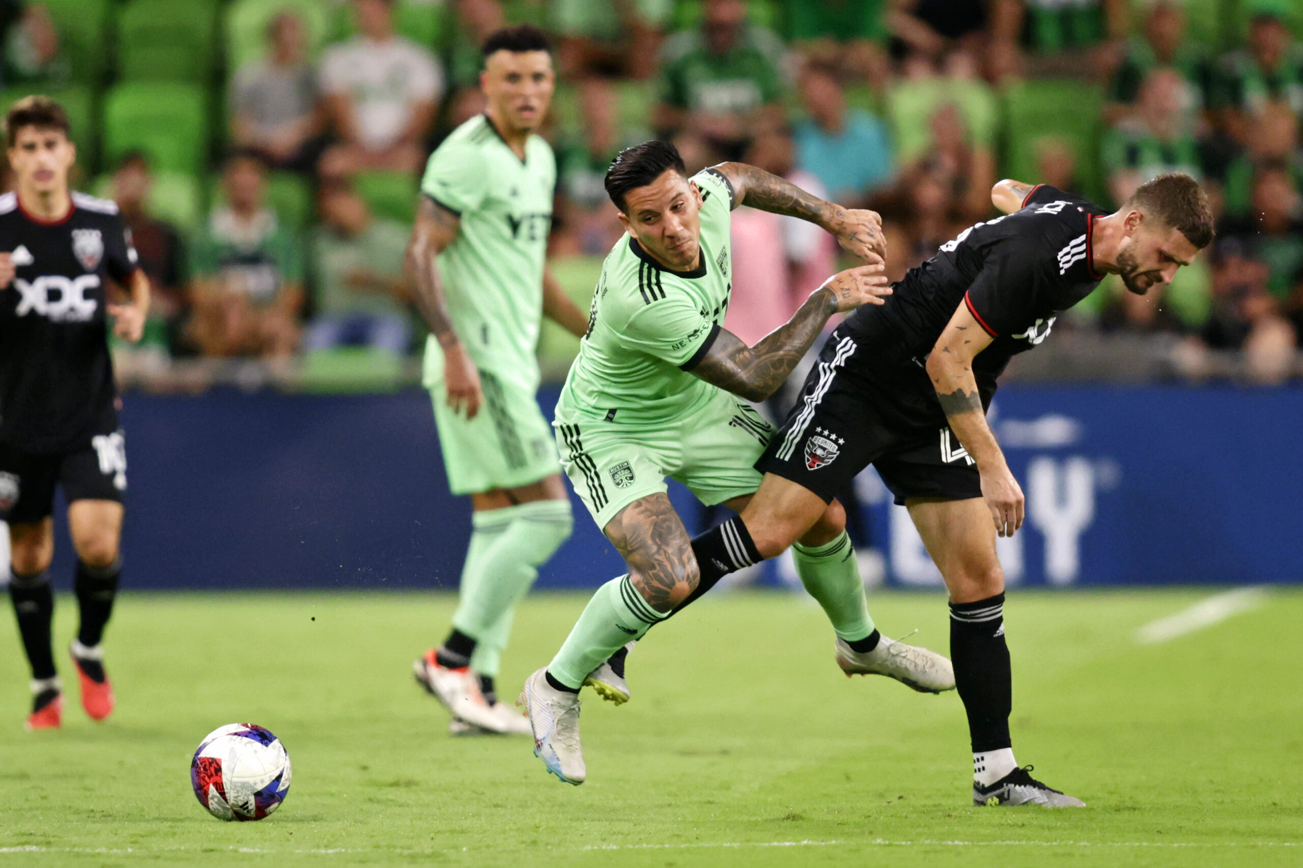 Oct 4, 2023; Austin, Texas, USA; Austin FC forward Sebastian Driussi (10) battles for the ball after the game D.C. United midfielder Mateusz Klich (43) during the game at Q2 Stadium. Mandatory Credit: Erich Schlegel-Imagn Images