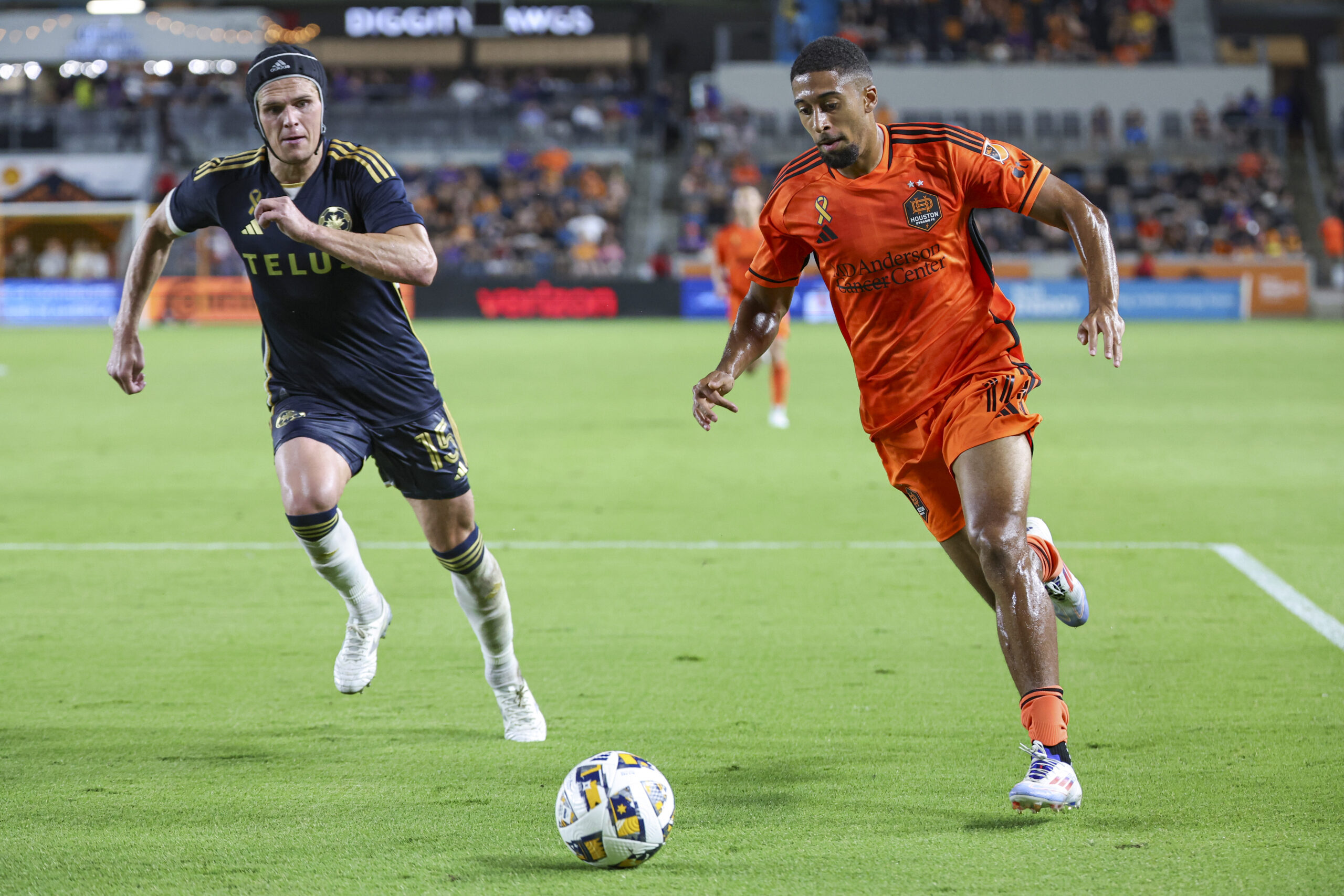 Sep 18, 2024; Houston, Texas, USA; Houston Dynamo FC defender McKinze Gaines (14) in action as Vancouver Whitecaps FC defender Bjorn Utvik (15) defends during the match at Shell Energy Stadium. Mandatory Credit: Troy Taormina-Imagn Images