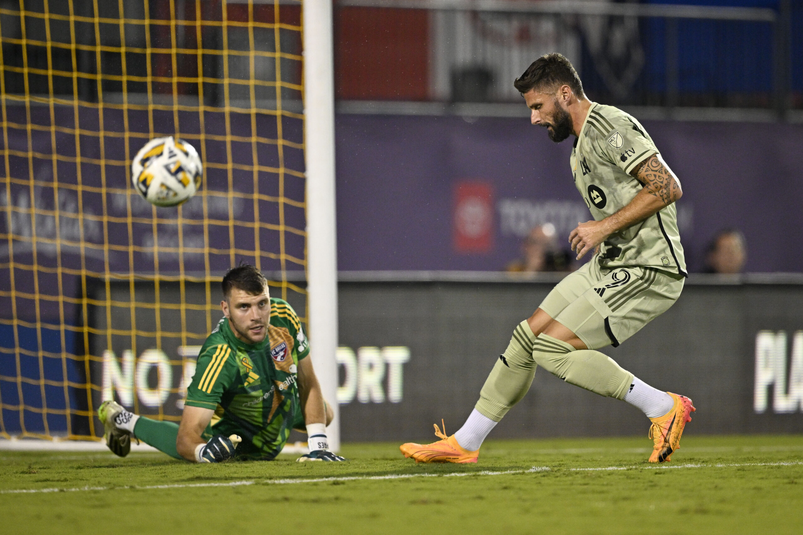 Sep 21, 2024; Frisco, Texas, USA; FC Dallas goalkeeper Maarten Paes (30) turns aside a shot as Los Angeles FC forward Olivier Giroud (9) looks for the rebound during the second half at Toyota Stadium. Mandatory Credit: Jerome Miron-Imagn Images