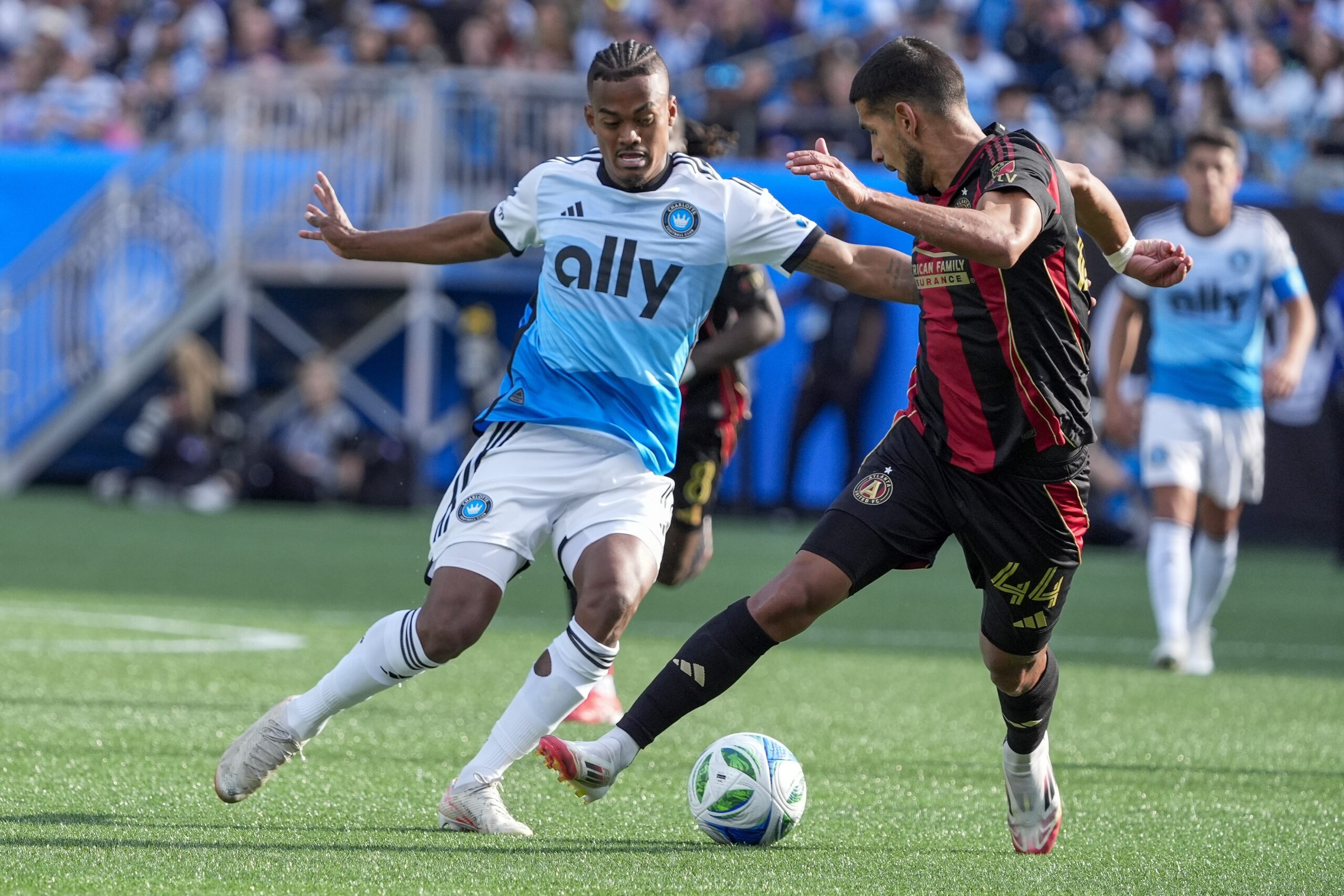 Mar 1, 2025; Charlotte, North Carolina, USA; Charlotte FC forward Kerwin Vargas (18) and Atlanta United defender Luis Abram (44) battle for the ball during the second half at Bank of America Stadium. Mandatory Credit: Jim Dedmon-Imagn Images