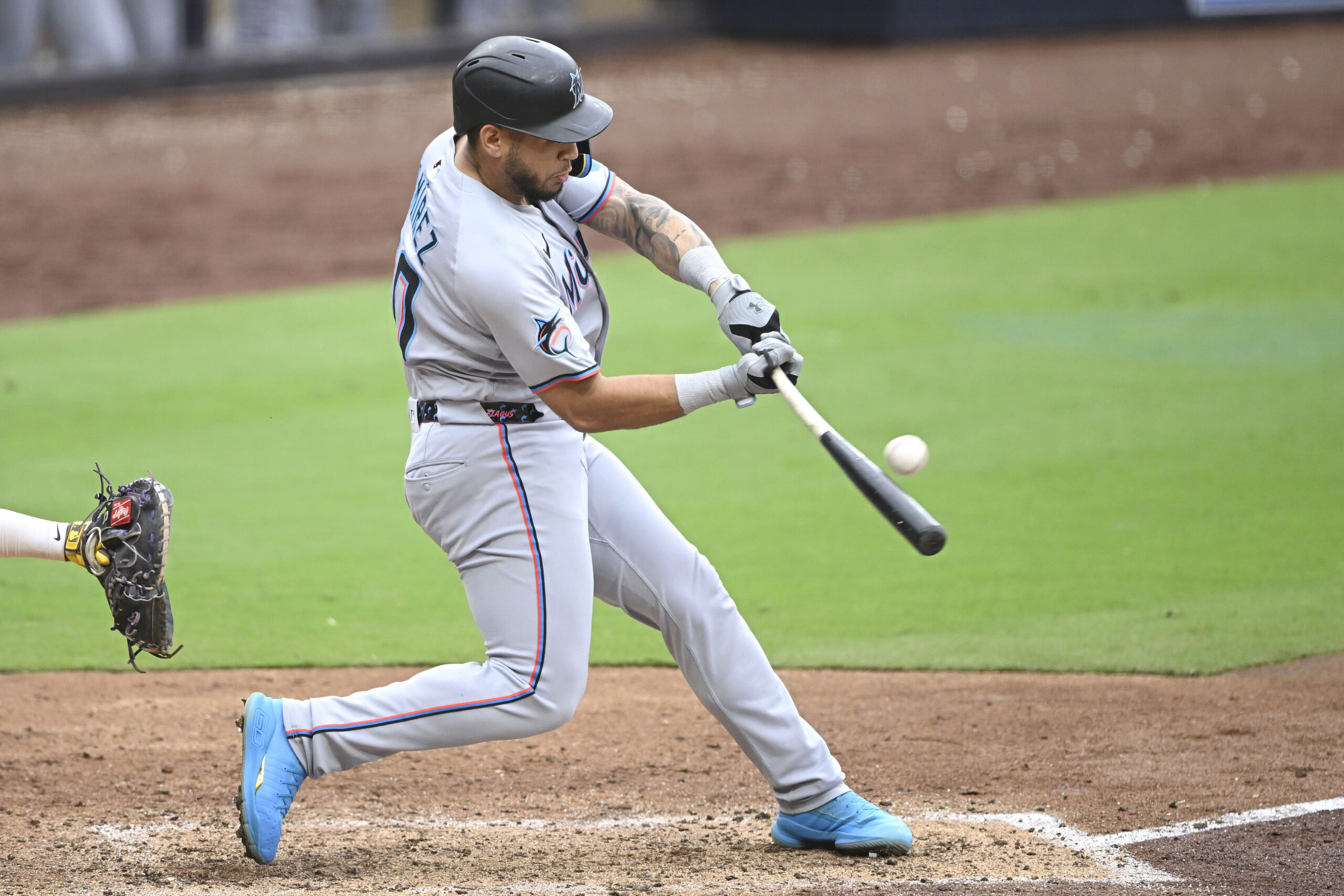 May 28, 2025; San Diego, California, USA; Miami Marlins catcher Agustin Ramirez (50) hits a single during the seventh inning against the San Diego Padres at Petco Park. Mandatory Credit: Denis Poroy-Imagn Images