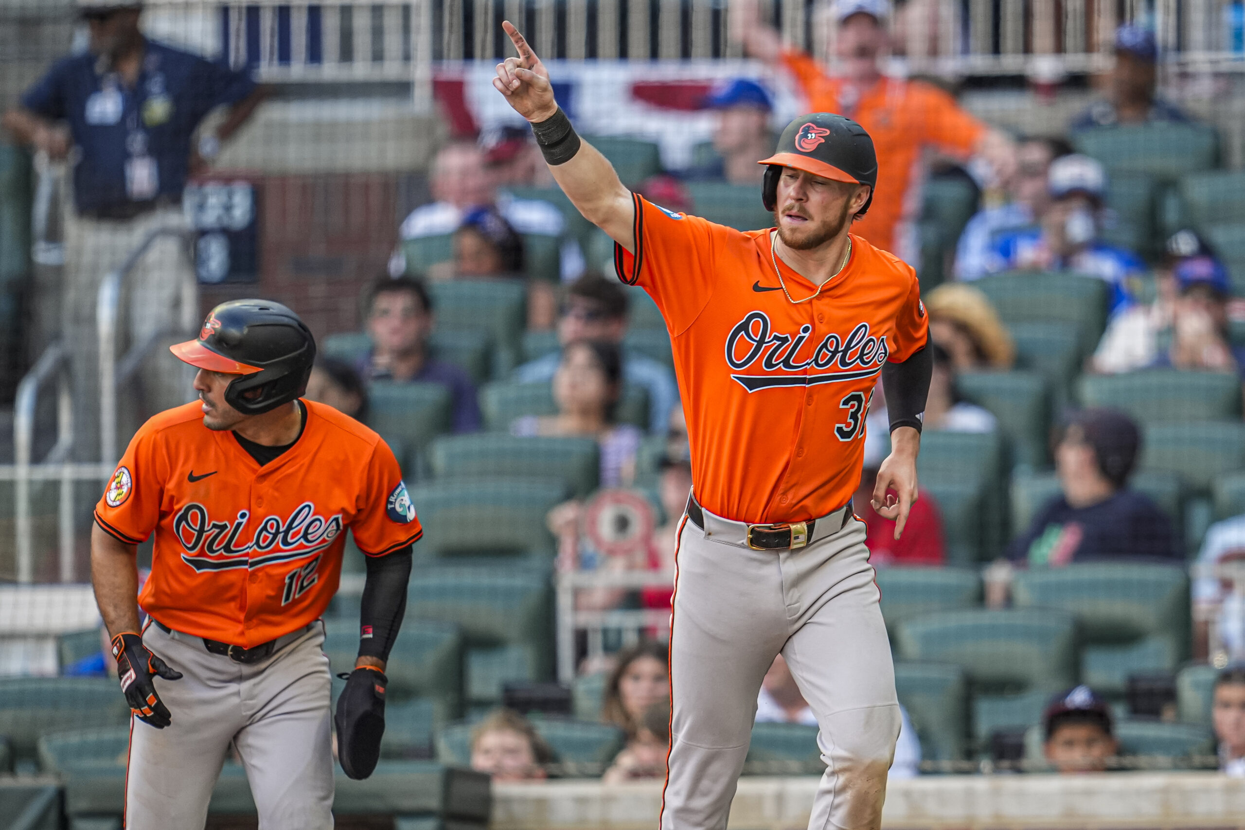 Jul 5, 2025; Cumberland, Georgia, USA; Baltimore Orioles first baseman Ryan O'Hearn (32) and right fielder Ramon Laureano (rear left) react after scoring against the Atlanta Braves during the tenth inning at Truist Park. Mandatory Credit: Dale Zanine-Imagn Images