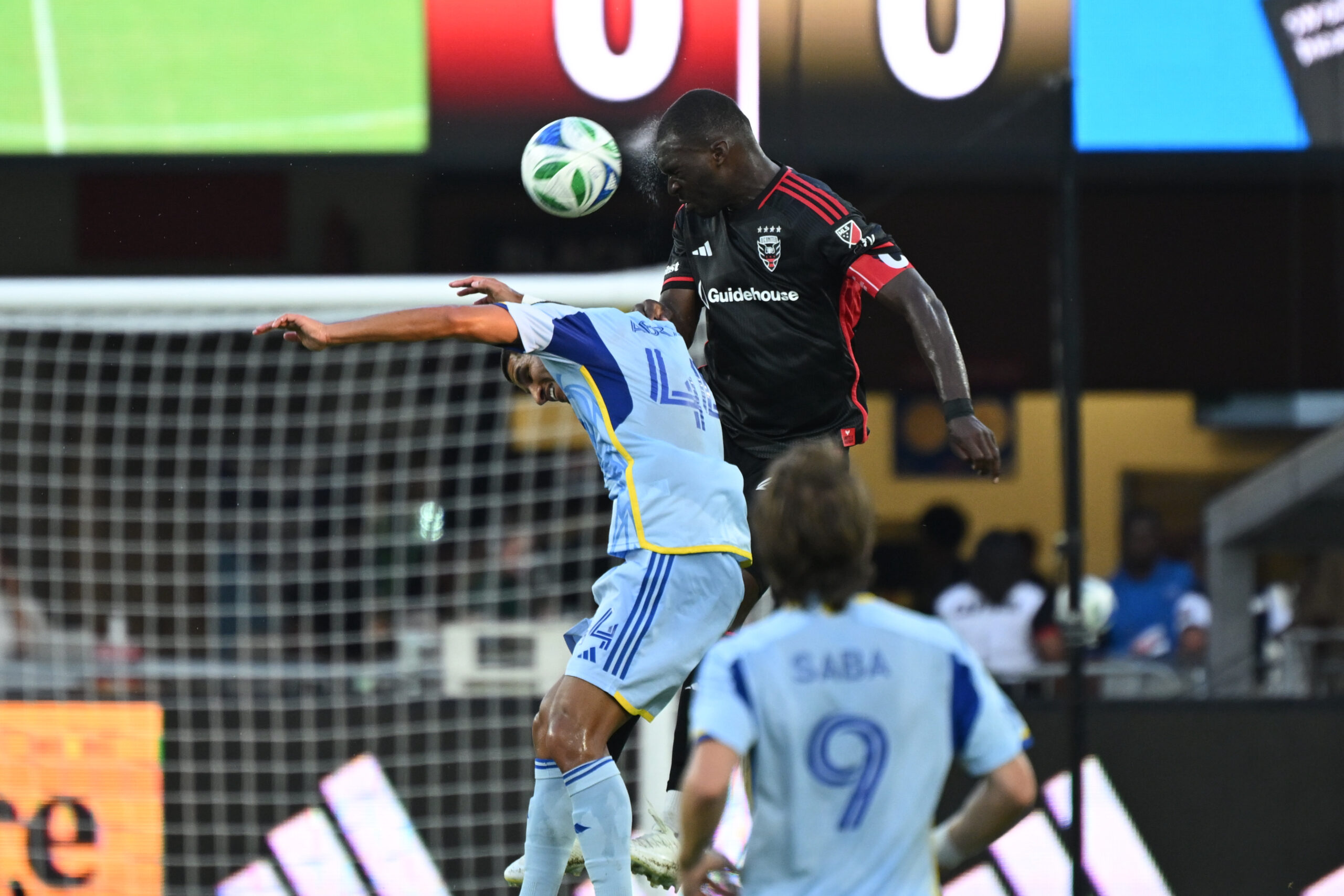 Jul 5, 2025; Washington, District of Columbia, USA; D.C. United forward Christian Benteke (20) battles Atlanta United defender Luis Abram (44) for the ball during the first half at Audi Field. Mandatory Credit: Rafael Suanes-Imagn Images