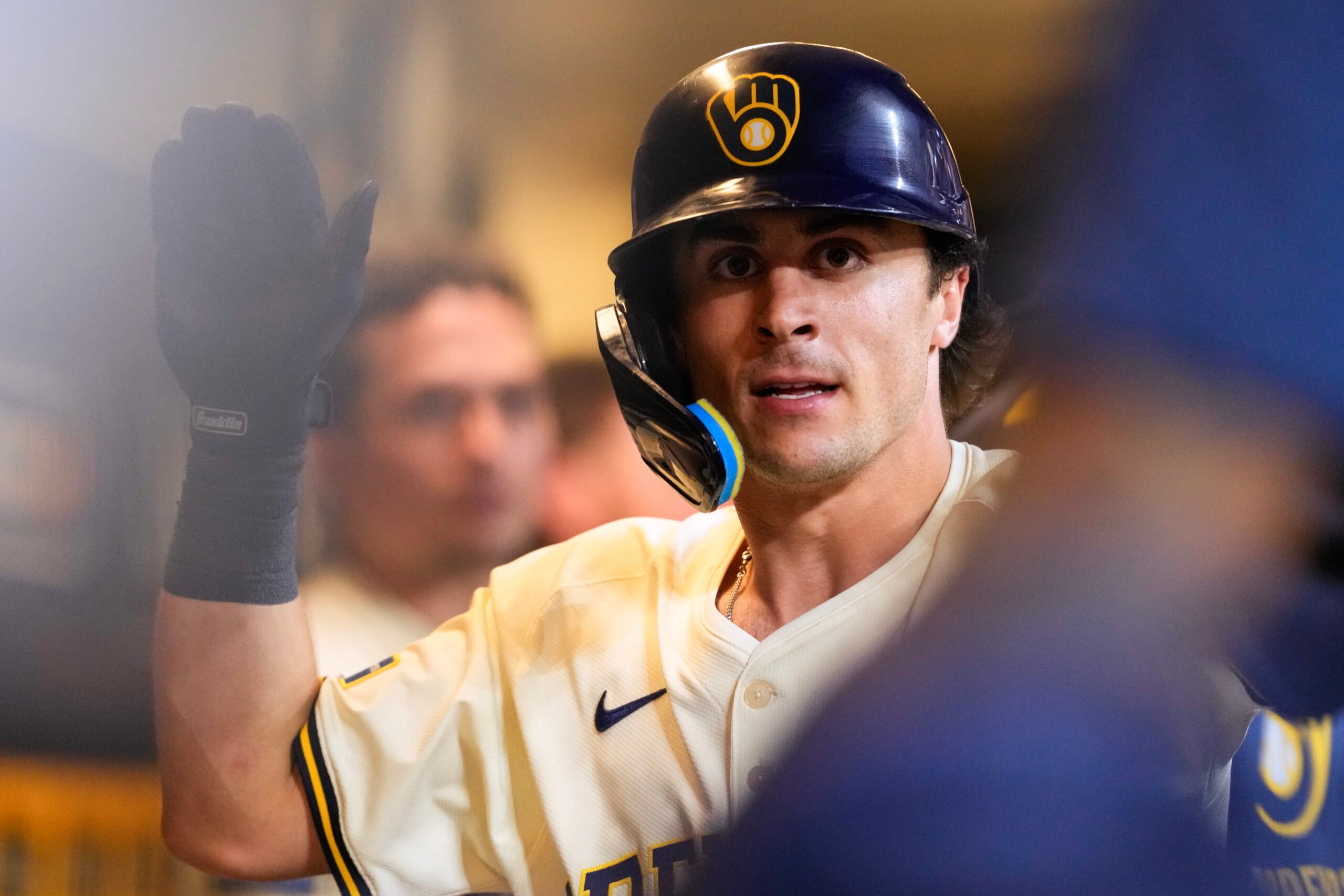 Jul 8, 2025; Milwaukee, Wisconsin, USA; Milwaukee Brewers right fielder Sal Frelick (10) high fives teammates in the dugout after hitting a home run during the eighth inning against the Los Angeles Dodgers at American Family Field. Mandatory Credit: Jeff Hanisch-Imagn Images