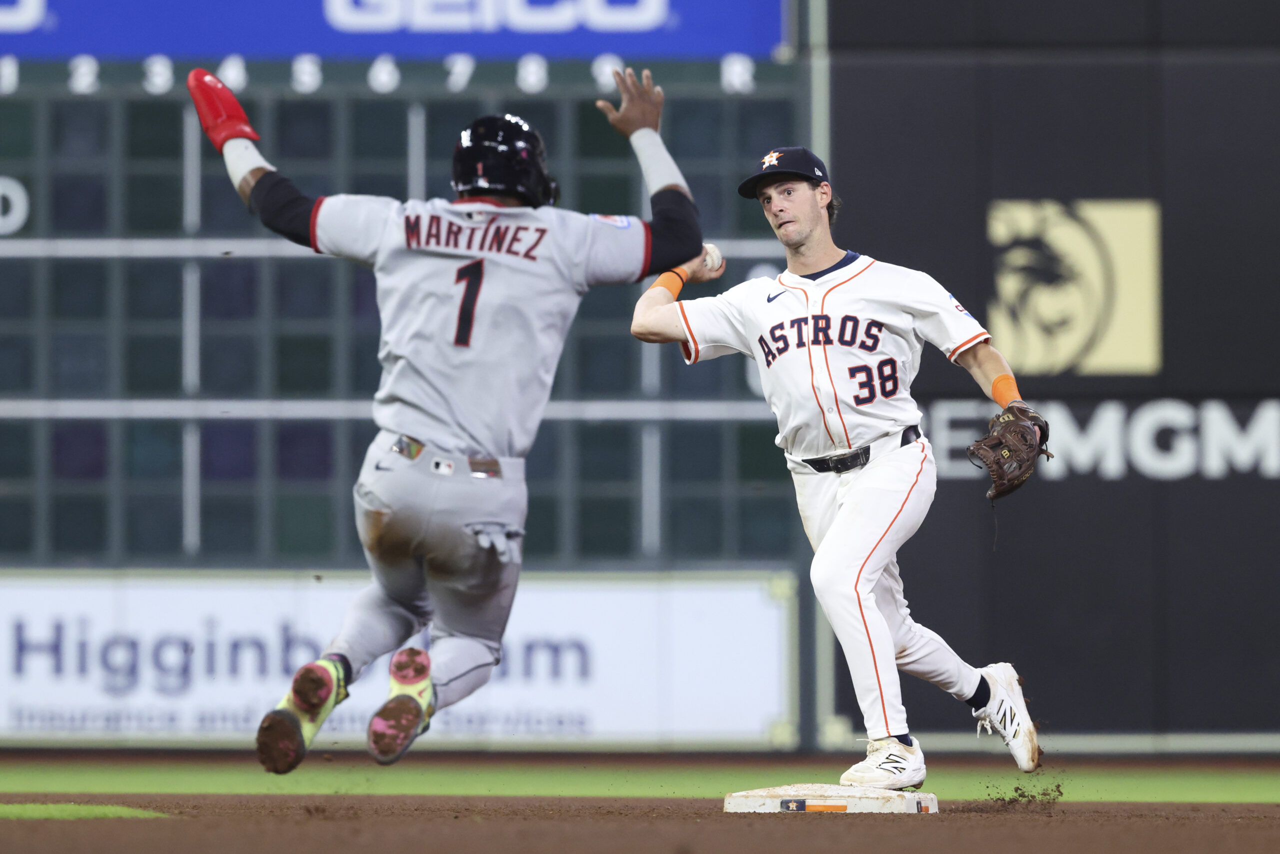Jul 8, 2025; Houston, Texas, USA; Cleveland Guardians second baseman Angel Martinez (1) is out and Houston Astros shortstop Zack Short (38) throws to first base for a double play during the sixth inning at Daikin Park. Mandatory Credit: Troy Taormina-Imagn Images
