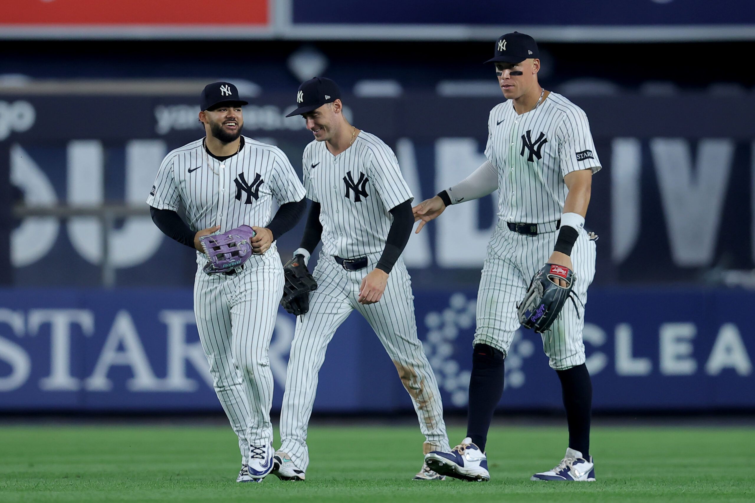 Jul 8, 2025; Bronx, New York, USA; New York Yankees left fielder Jasson Dominguez (24) and center fielder Cody Bellinger (35) and right fielder Aaron Judge (99) celebrate after defeating the Seattle Mariners at Yankee Stadium. Mandatory Credit: Brad Penner-Imagn Images