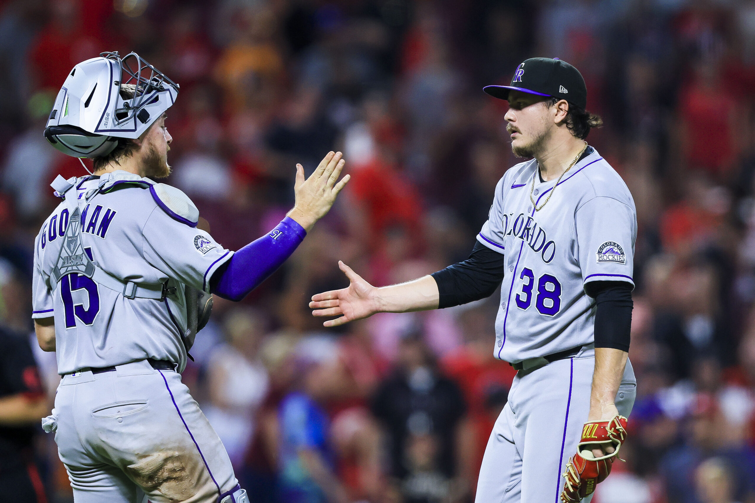 Jul 11, 2025; Cincinnati, Ohio, USA; Colorado Rockies catcher Hunter Goodman (15) high fives relief pitcher Victor Vodnik (38) after the victory over the Cincinnati Reds at Great American Ball Park. Mandatory Credit: Katie Stratman-Imagn Images