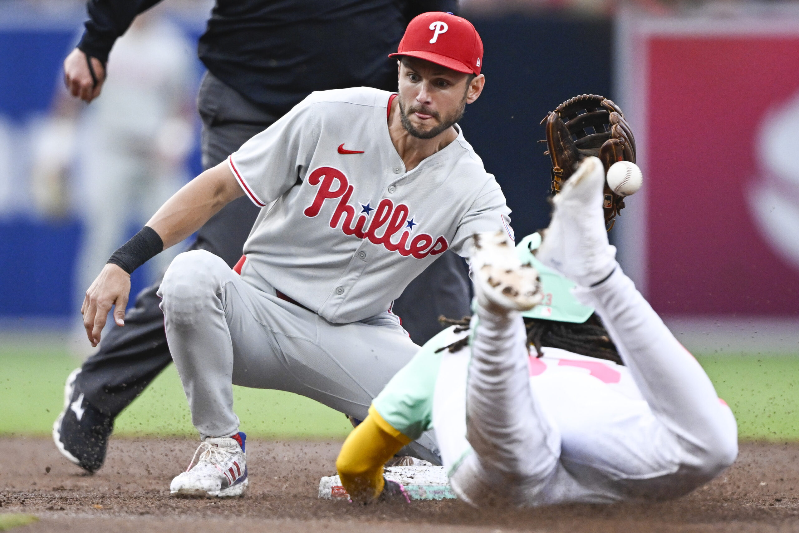 Jul 11, 2025; San Diego, California, USA; San Diego Padres right fielder Fernando Tatis Jr. (23) steals second base as Philadelphia Phillies shortstop Trea Turner (7) loses the ball during the third inning at Petco Park. Mandatory Credit: Denis Poroy-Imagn Images