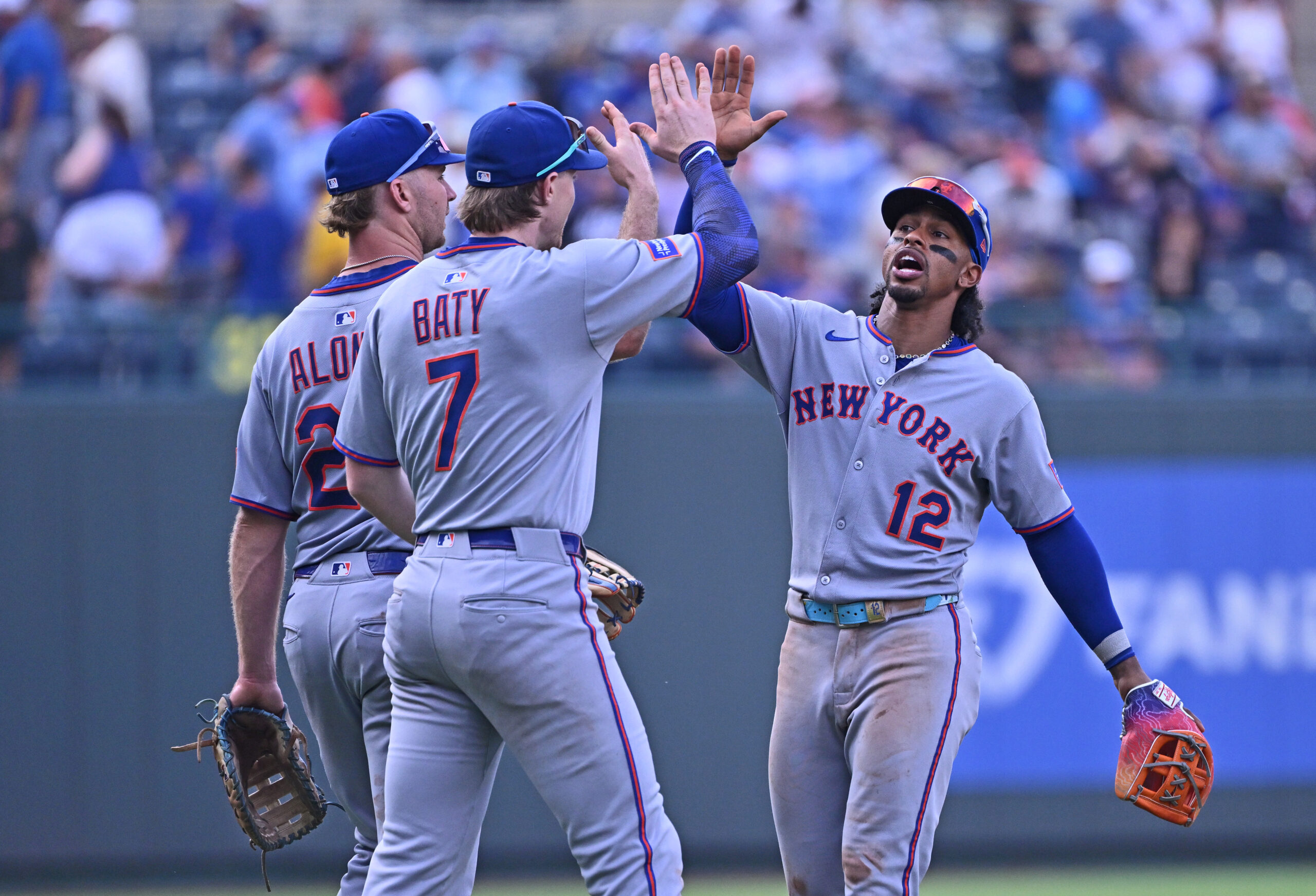 Jul 12, 2025; Kansas City, Missouri, USA;  New York Mets shortstop Francisco Lindor (12) celebrates with teammates second baseman Brett Baty (7) and first baseman Pete Alonso (20) after beating the Kansas City Royals at Kauffman Stadium. Mandatory Credit: Peter Aiken-Imagn Images