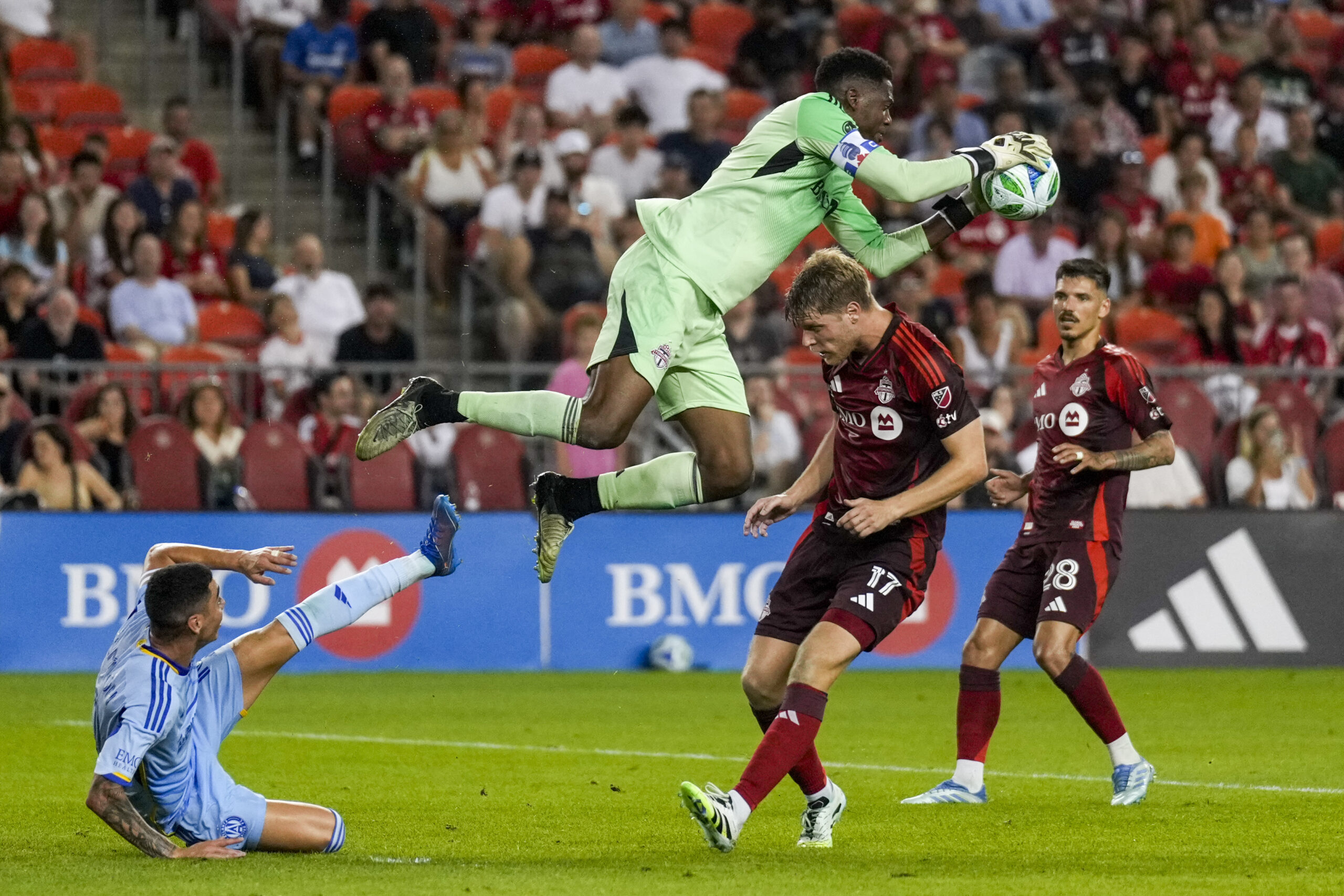 Jul 12, 2025; Toronto, Ontario, CAN; Toronto FC goalkeeper Sean Johnson (1) makes a save against Atlanta United midfielder Miguel Almirón (10) during the second half at BMO Field. Mandatory Credit: Kevin Sousa-Imagn Images
