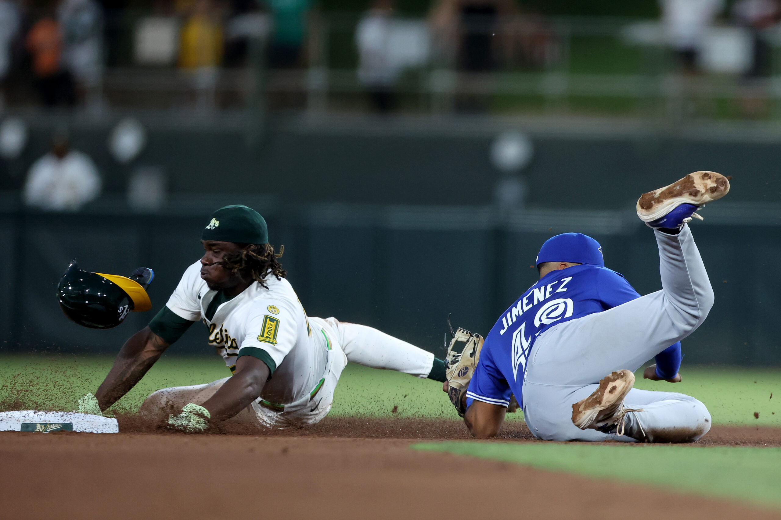 Jul 12, 2025; West Sacramento, California, USA; Athletics right fielder Lawrence Butler (4) is tagged out by Toronto Blue Jays second baseman Leo Jimenez (49) on a steal attempt during the fifth inning at Sutter Health Park. Mandatory Credit: Dennis Lee-Imagn Images