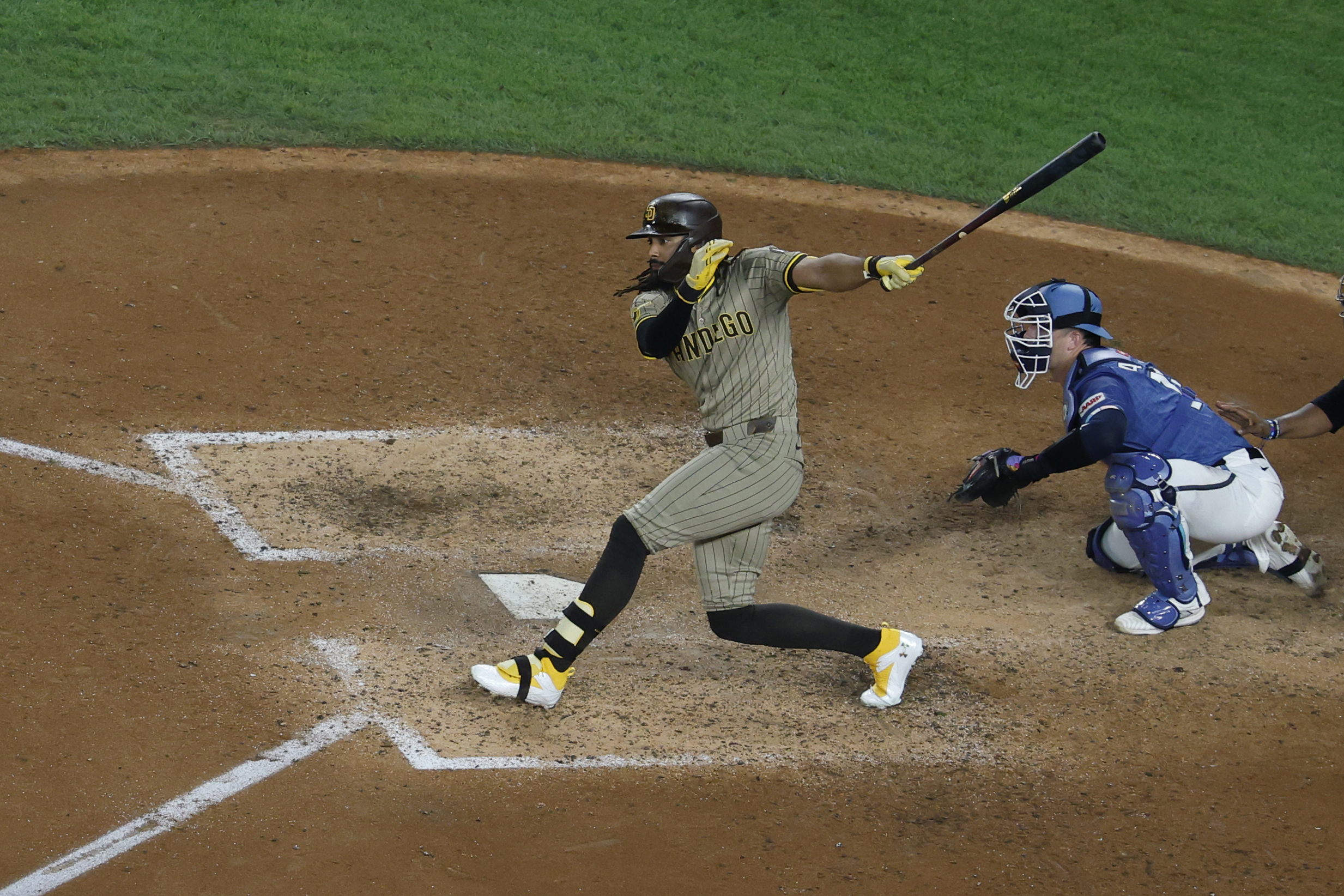 Jul 18, 2025; Washington, District of Columbia, USA; San Diego Padres outfielder Fernando Tatis Jr. (23) singles against the Washington Nationals during the ninth inning at Nationals Park. Mandatory Credit: Geoff Burke-Imagn Images