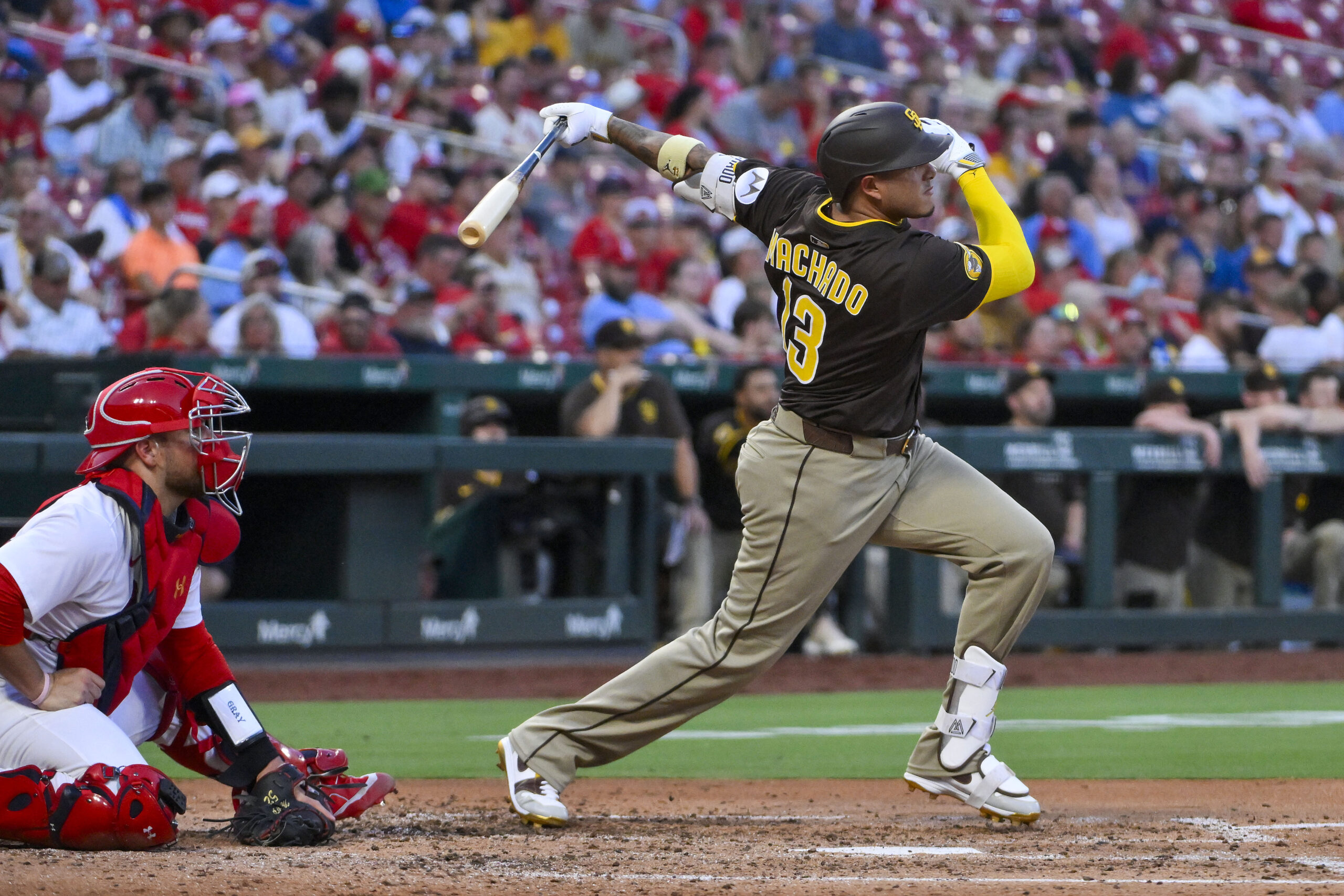 Jul 24, 2025; St. Louis, Missouri, USA; San Diego Padres third baseman Manny Machado (13) hits a two run home run against the St. Louis Cardinals during the third inning at Busch Stadium. Mandatory Credit: Jeff Curry-Imagn Images