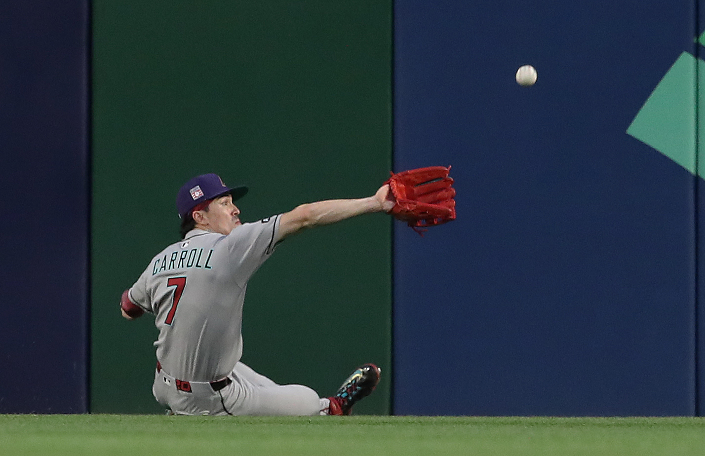 Jul 26, 2025; Pittsburgh, Pennsylvania, USA; Arizona Diamondbacks center fielder Corbin Carroll (7) makes a catch for an out against Pittsburgh Pirates third baseman Ke'Bryan Hayes (not pictured) during the fourth inning at PNC Park. Mandatory Credit: Charles LeClaire-Imagn Images
