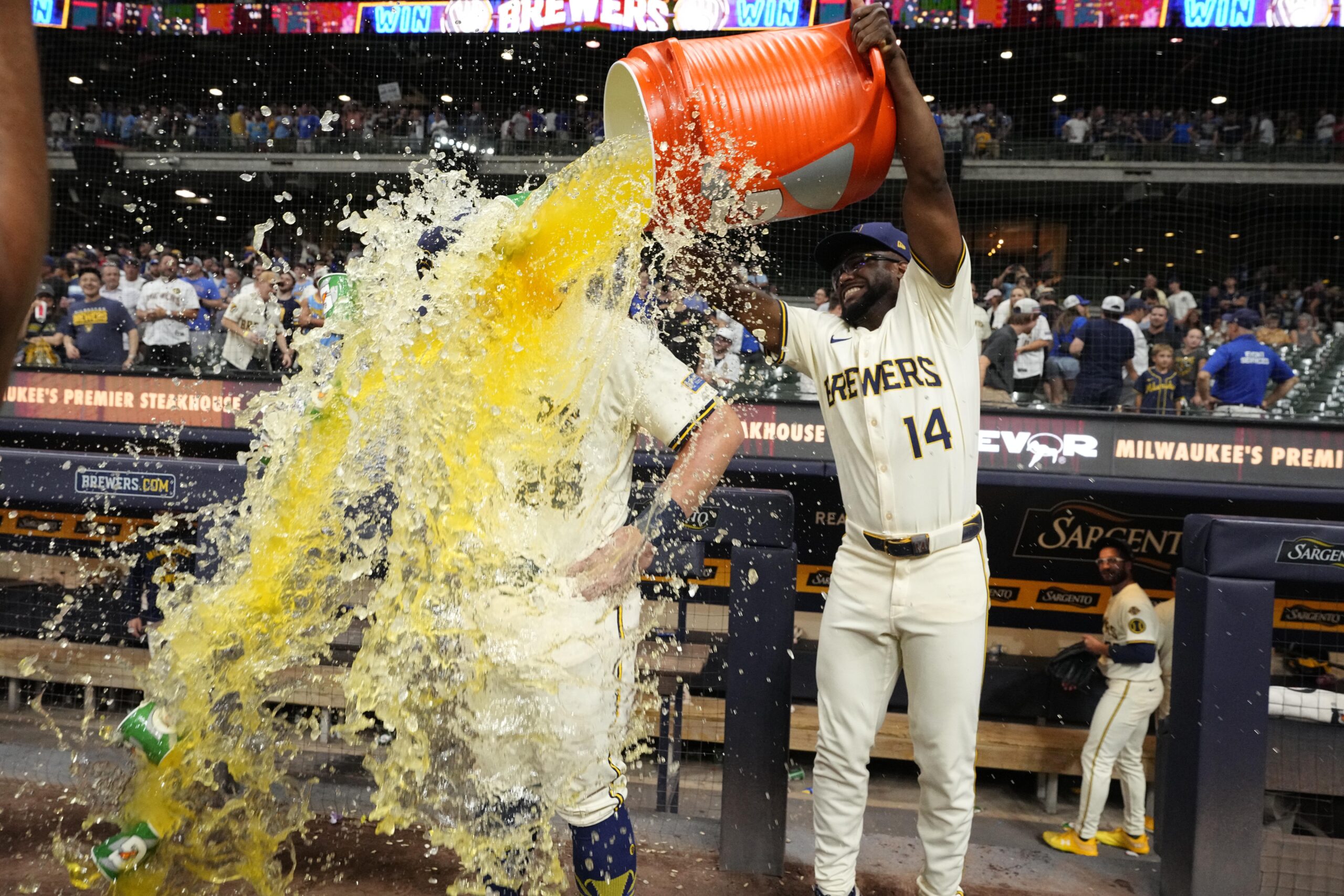 Jul 29, 2025; Milwaukee, Wisconsin, USA; Milwaukee Brewers shortstop Andruw Monasterio (14) dumps Gatorade over Milwaukee Brewers first base Andrew Vaughn (28) head after the game in which Milwaukee Andrew Vaughn (28) hit a grand slam against the Chicago Cubs at American Family Field. Mandatory Credit: Michael McLoone-Imagn Images