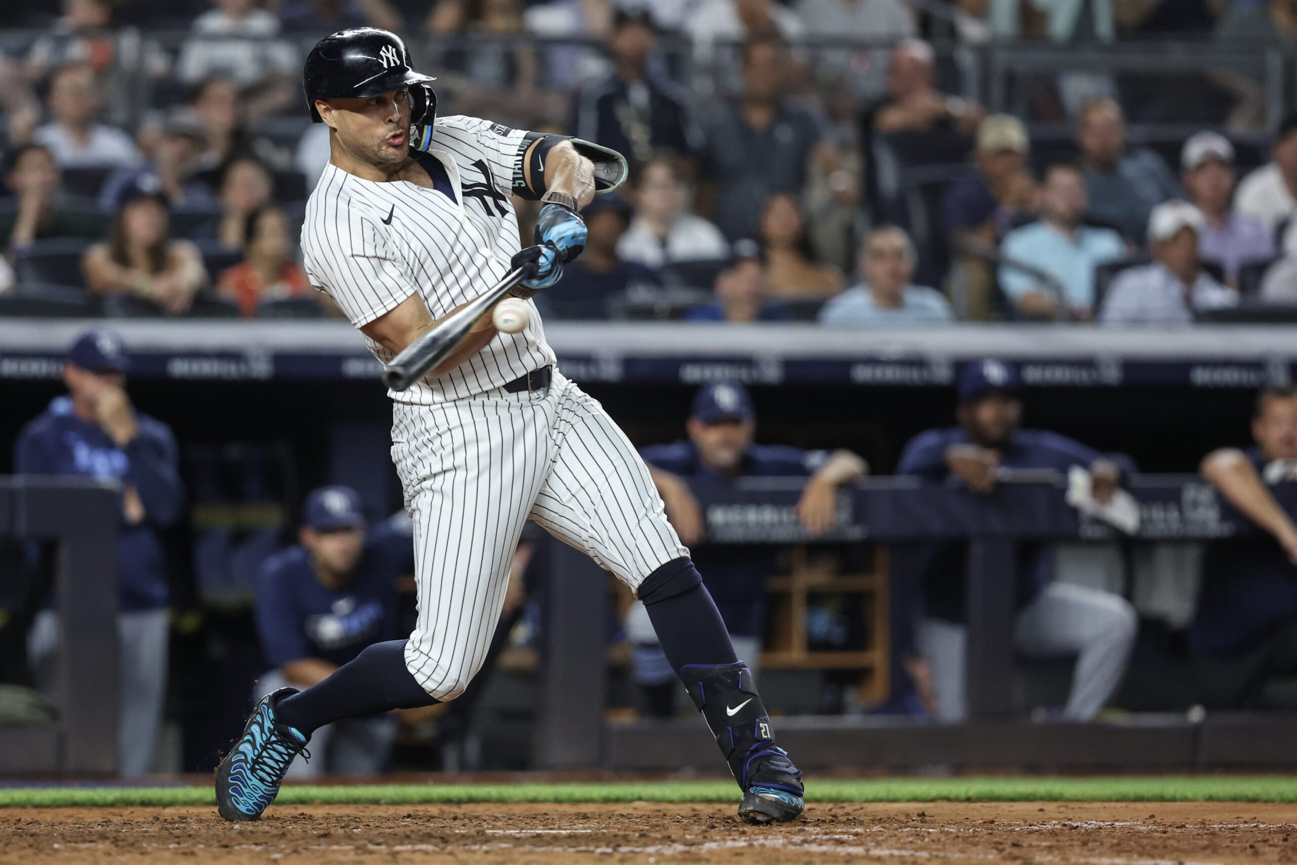 Jul 30, 2025; Bronx, New York, USA; New York Yankees designated hitter Giancarlo Stanton (27) hits an RBI single in the eighth inning against the Tampa Bay Rays at Yankee Stadium. Mandatory Credit: Wendell Cruz-Imagn Images