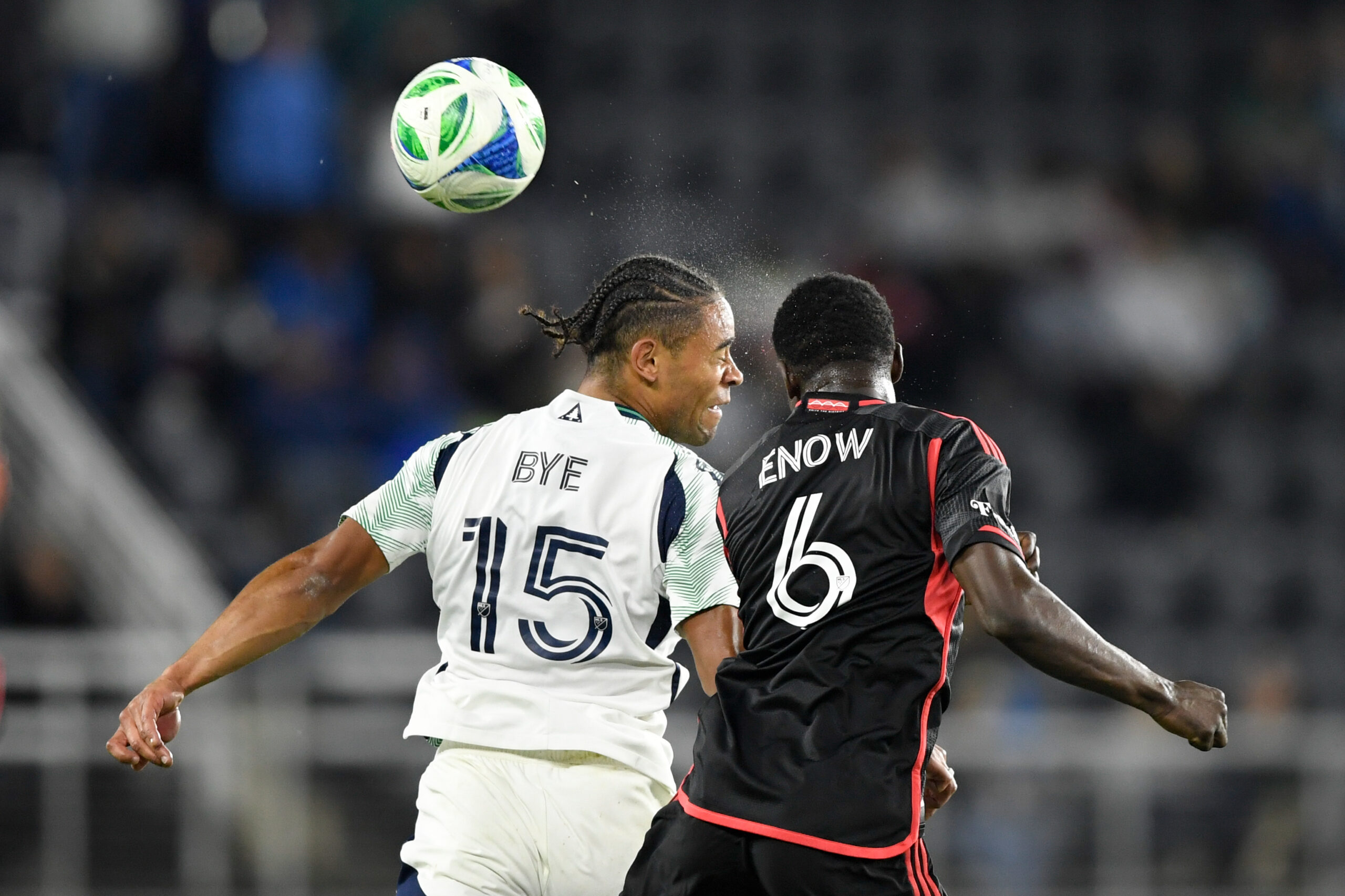 May 28, 2025; Washington, District of Columbia, USA; New England Revolution midfielder Brandon Bye (15) and D.C. United midfielder Boris Enow (6) go after the ball during the second half of the game at Audi Field. Mandatory Credit: Hannah Foslien-Imagn Images
