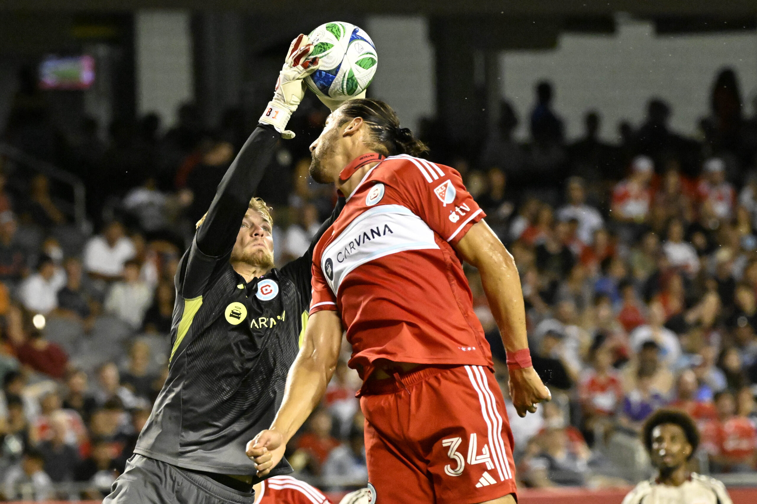 Jul 26, 2025; Chicago, Illinois, USA; Chicago Fire goalkeeper Chris Brady (1) and defender Omar González (34) defend against the New York Red Bulls during the second half at Soldier Field. Mandatory Credit: Matt Marton-Imagn Images