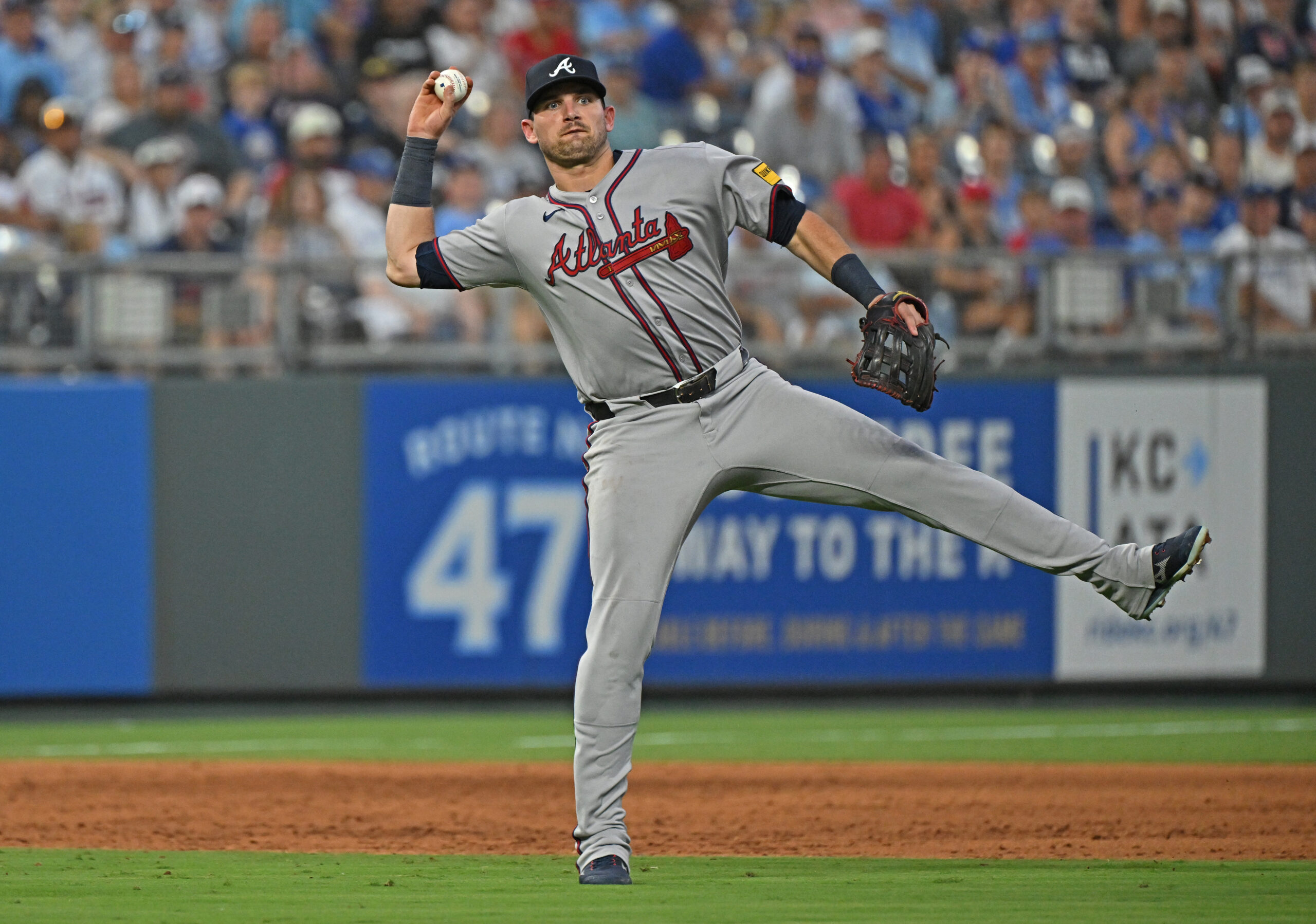 Jul 28, 2025; Kansas City, Missouri, USA; Atlanta Braves third baseman Austin Riley (27) throws the ball to first base in the sixth inning against the Kansas City Royals at Kauffman Stadium. Mandatory Credit: Peter Aiken-Imagn Images