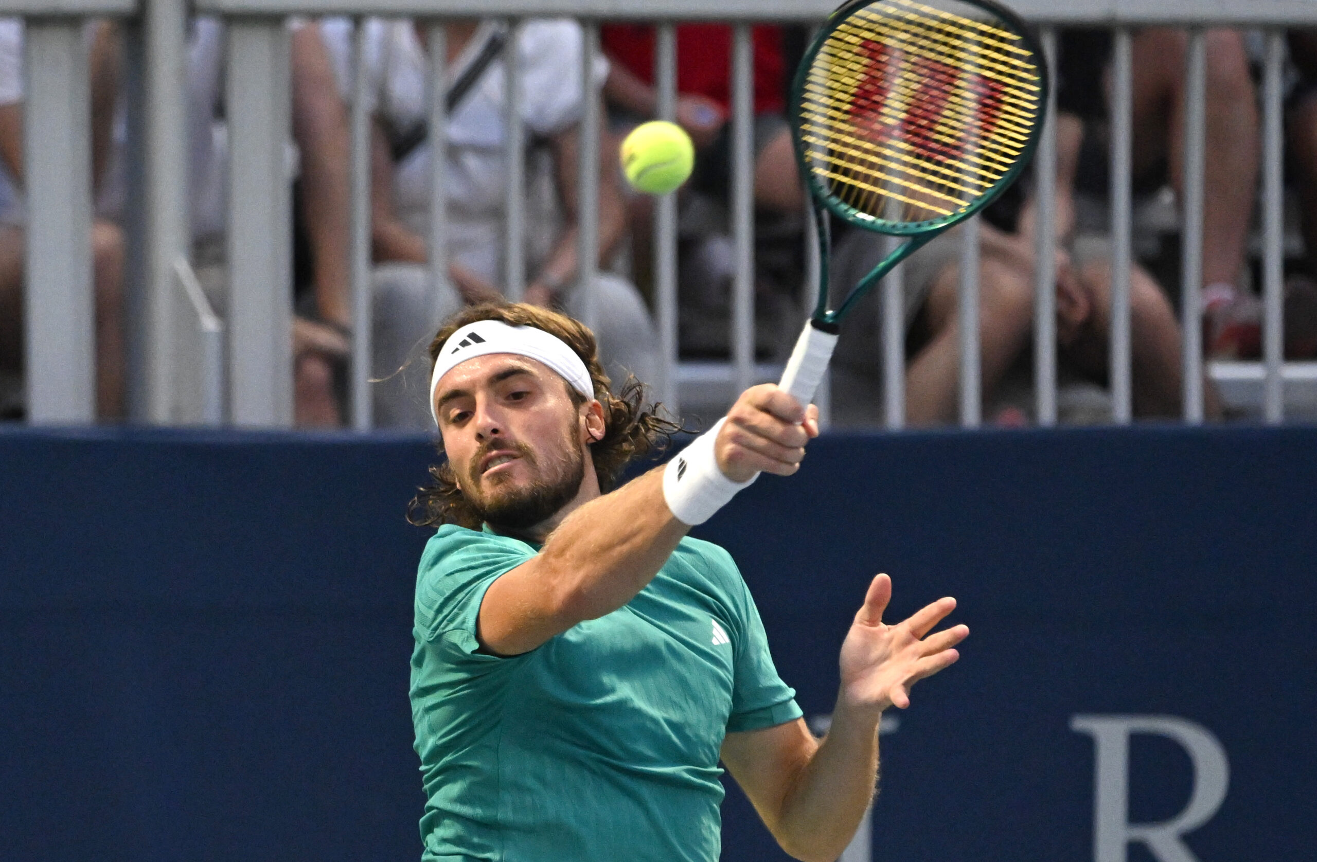 Jul 30, 2025; Toronto, ON, Canada; Stefanos Tsitsipas (GRE) plays a shot against Christopher O'Connell (AUS) during second round play at Sobeys Stadium. Mandatory Credit: Dan Hamilton-Imagn Images
