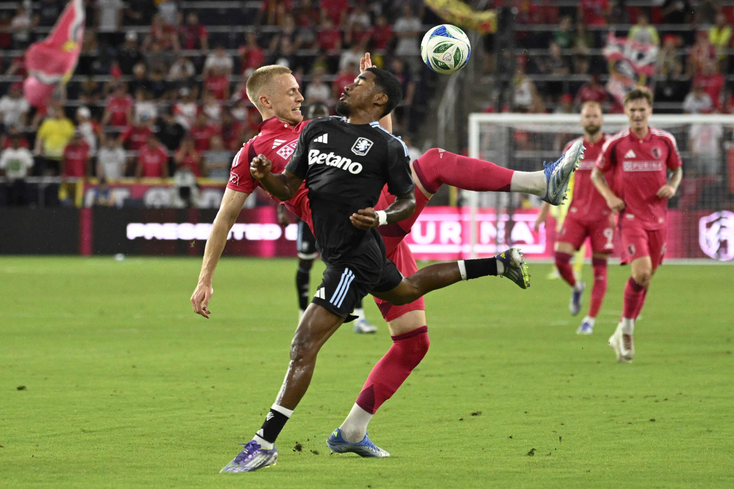 Jul 30, 2025; St. Louis, Missouri, USA; St. Louis City defender Timo Baumgartl (32) and Aston Villa defender Ian Maatsen (22) battle for the ball in the first half at Energizer Park. Mandatory Credit: Joe Puetz-Imagn Images