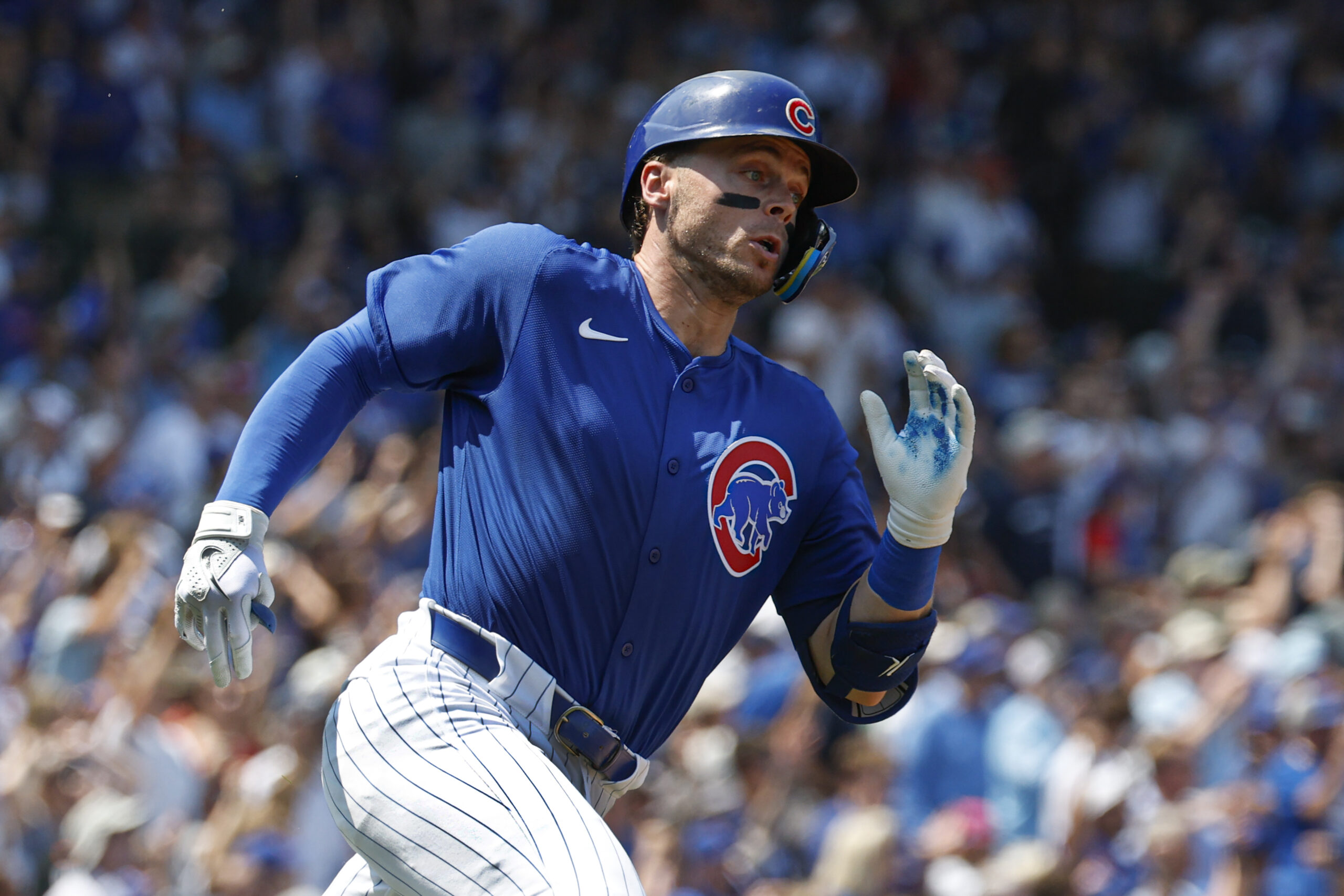 Aug 2, 2025; Chicago, Illinois, USA; Chicago Cubs shortstop Nico Hoerner wearing number 23 in honor the late Hall of Fame second baseman Ryne Sandberg runs after hitting an RBI-ground rule double against the Baltimore Orioles during the second inning at Wrigley Field. Mandatory Credit: Kamil Krzaczynski-Imagn Images