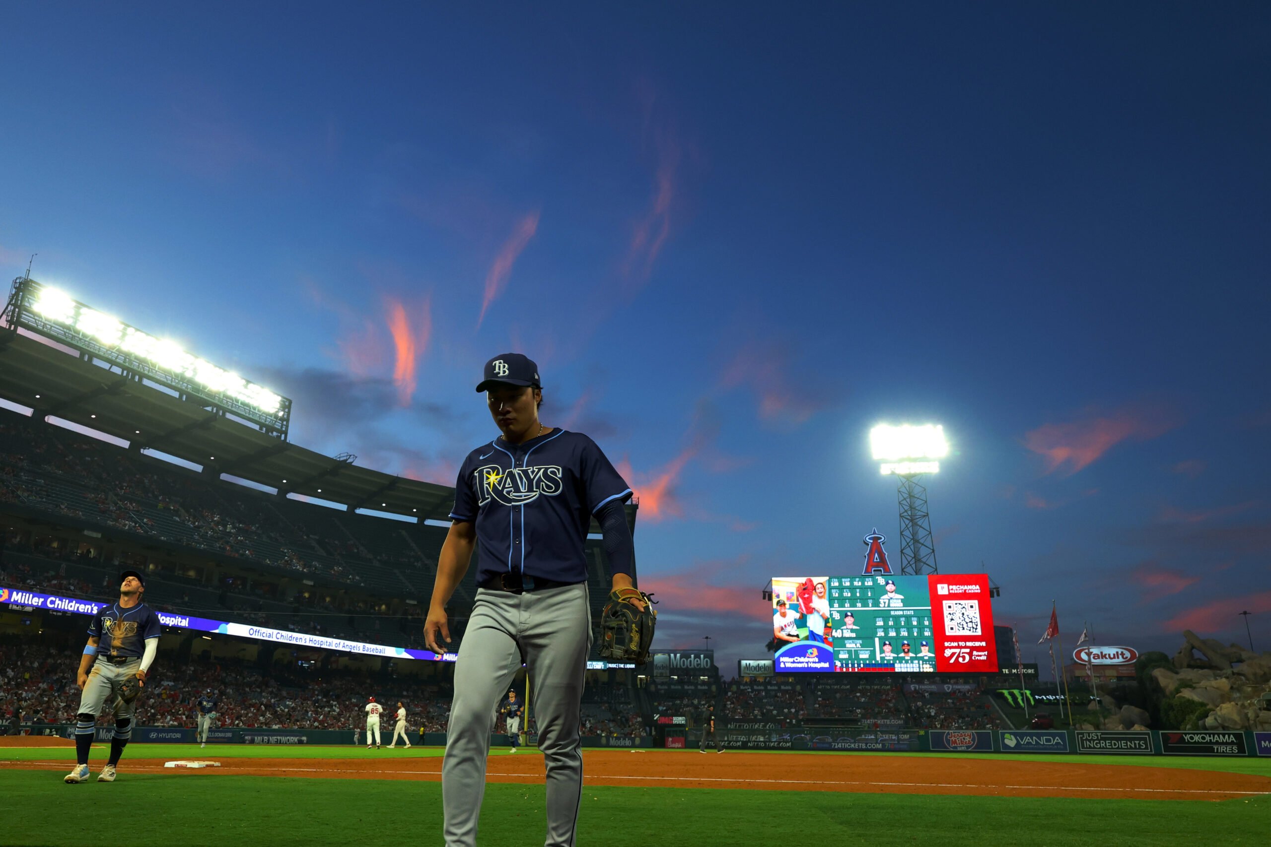 Aug 4, 2025; Anaheim, California, USA; Tampa Bay Rays second baseman Ha-Seong Kim (7) walks back to the dugout between the fourth inning against the Los Angeles Angels at Angel Stadium. Mandatory Credit: Kiyoshi Mio-Imagn Images